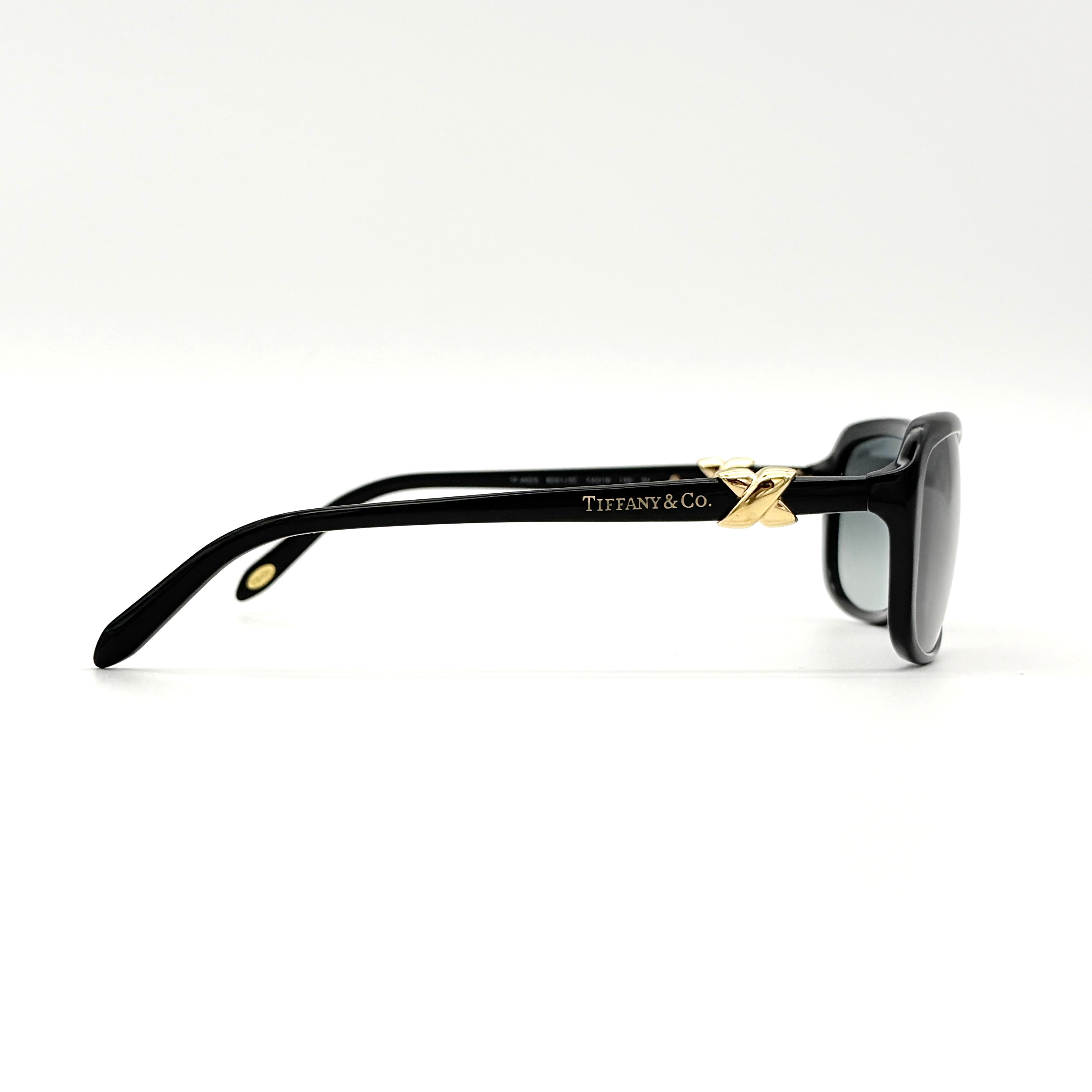 Tiffany & Co. TF4023 sunglasses in black with gold hardware, displayed with original turquoise case and accessories.