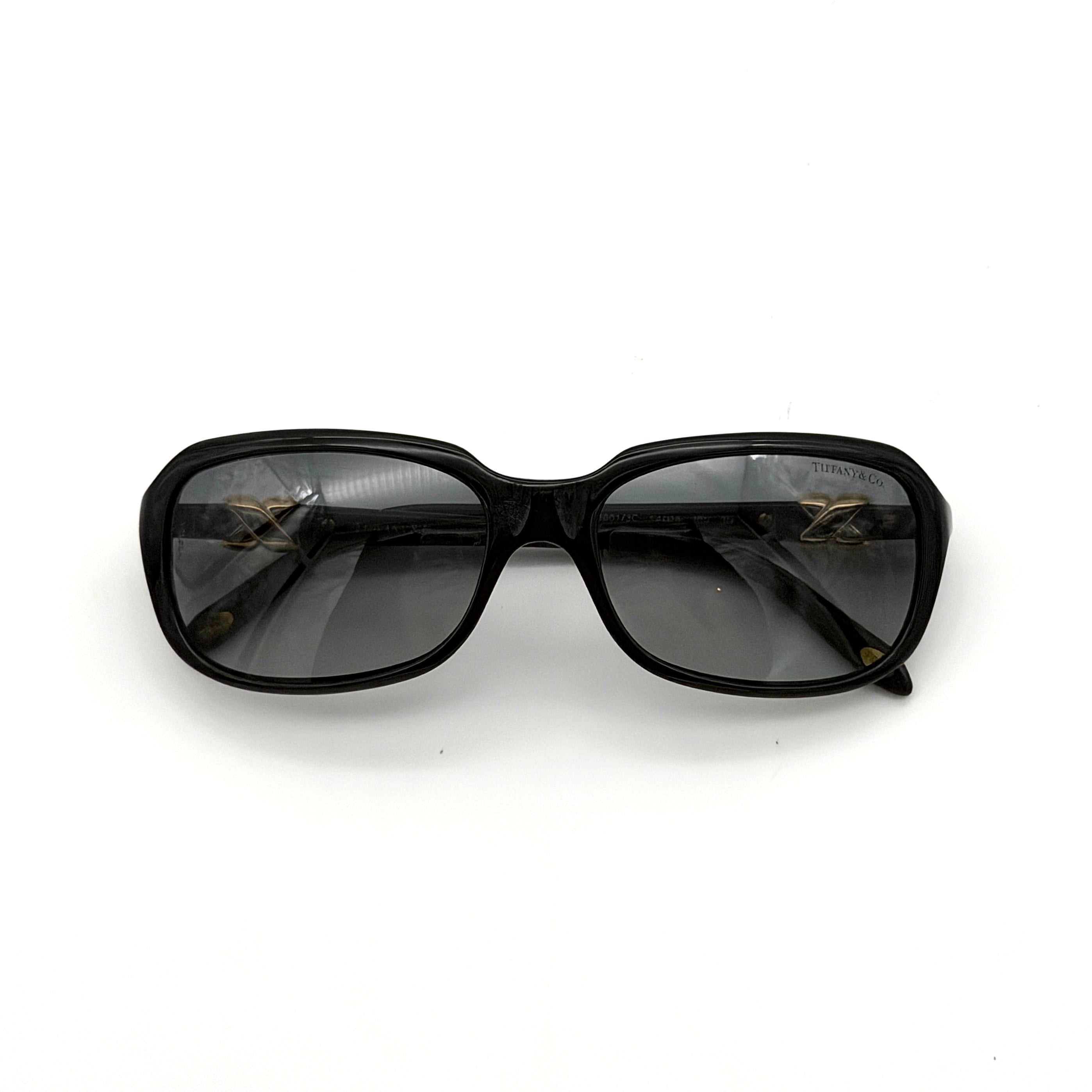 Tiffany & Co. TF4023 sunglasses in black with gold hardware, displayed with original turquoise case and accessories.