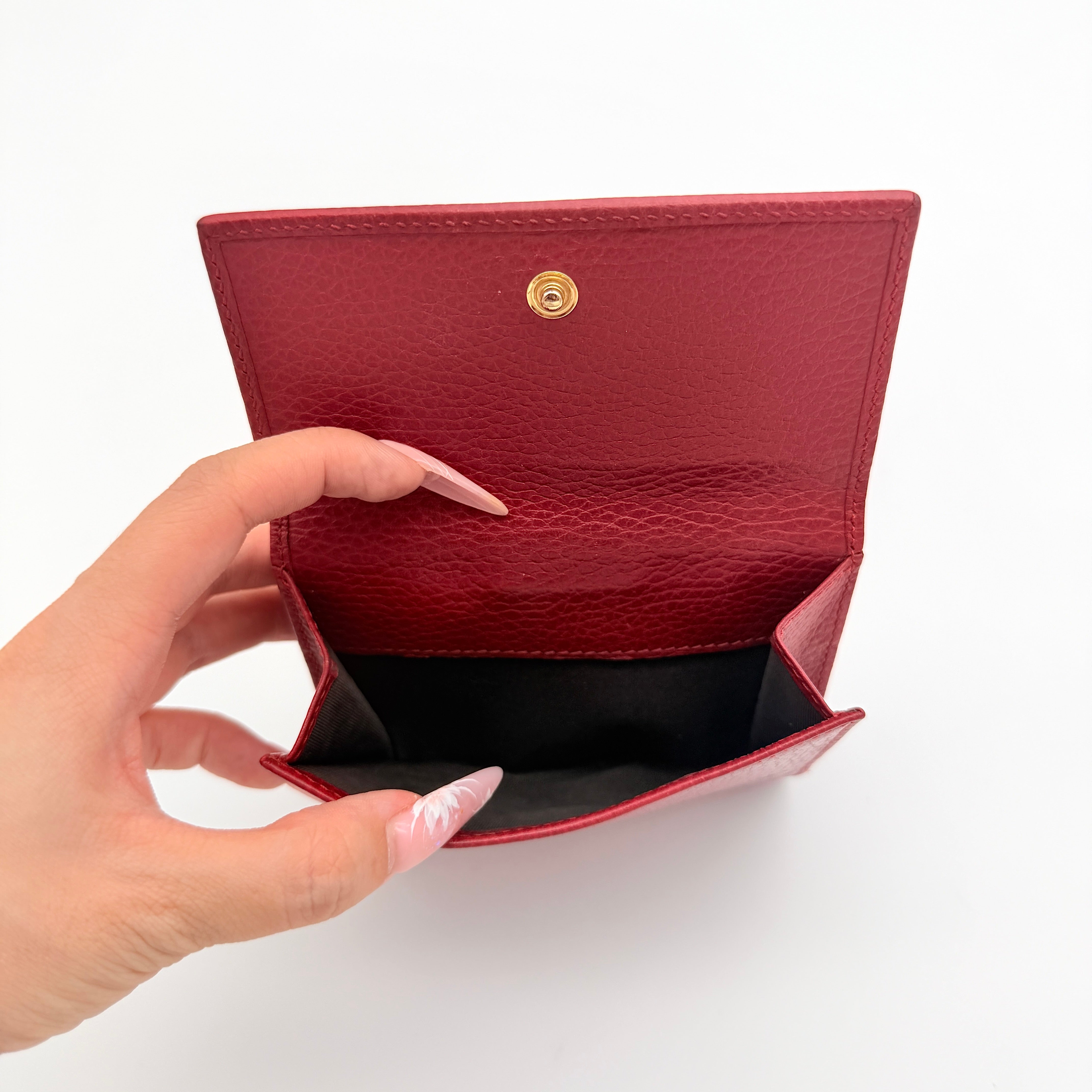 Gucci GG Marmont wallet in red grained leather with gold GG logo, presented with original box and dust bag.