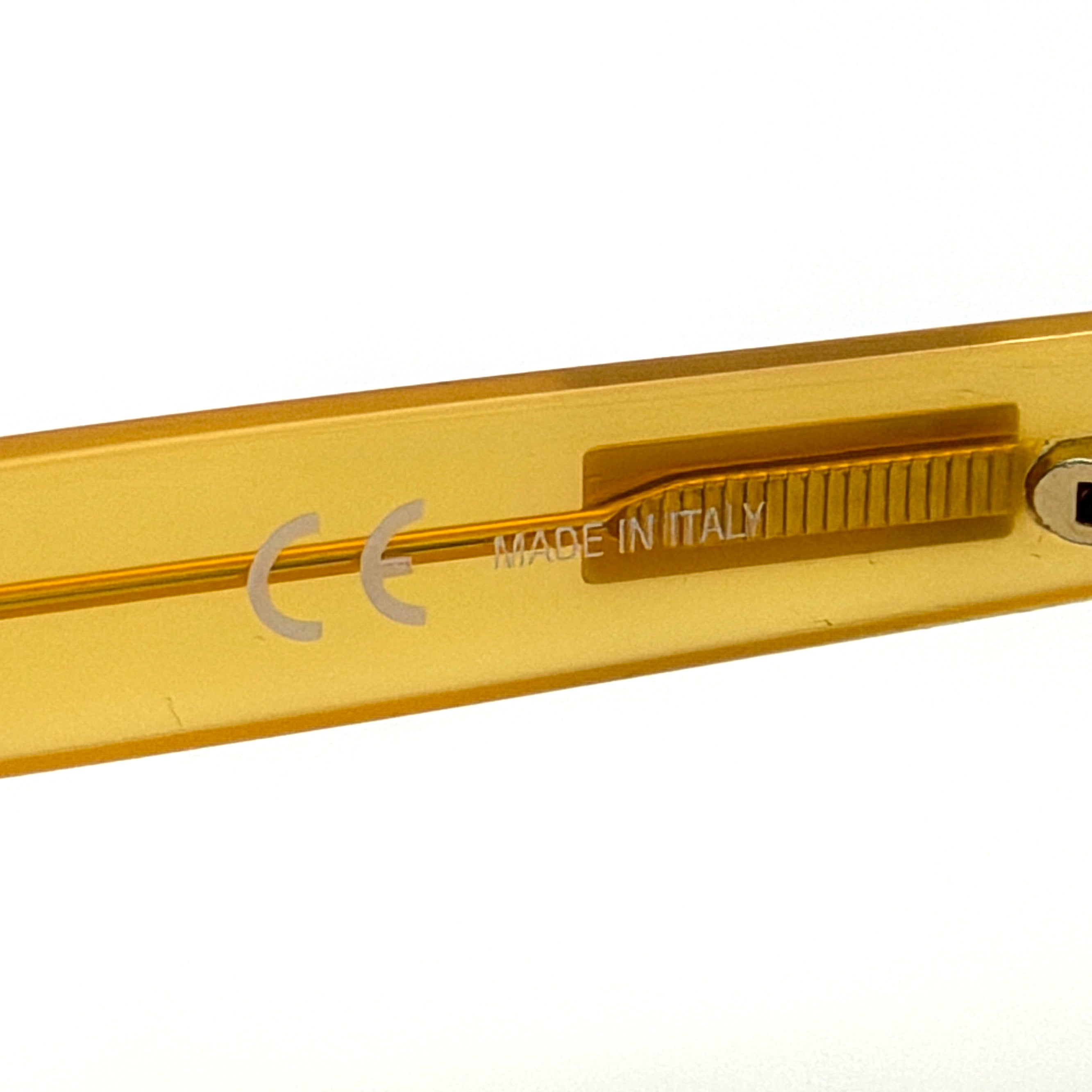 Supreme Downtown Sunglasses SS21 in translucent gold with vivid blue round lenses, set before a black Supreme case.