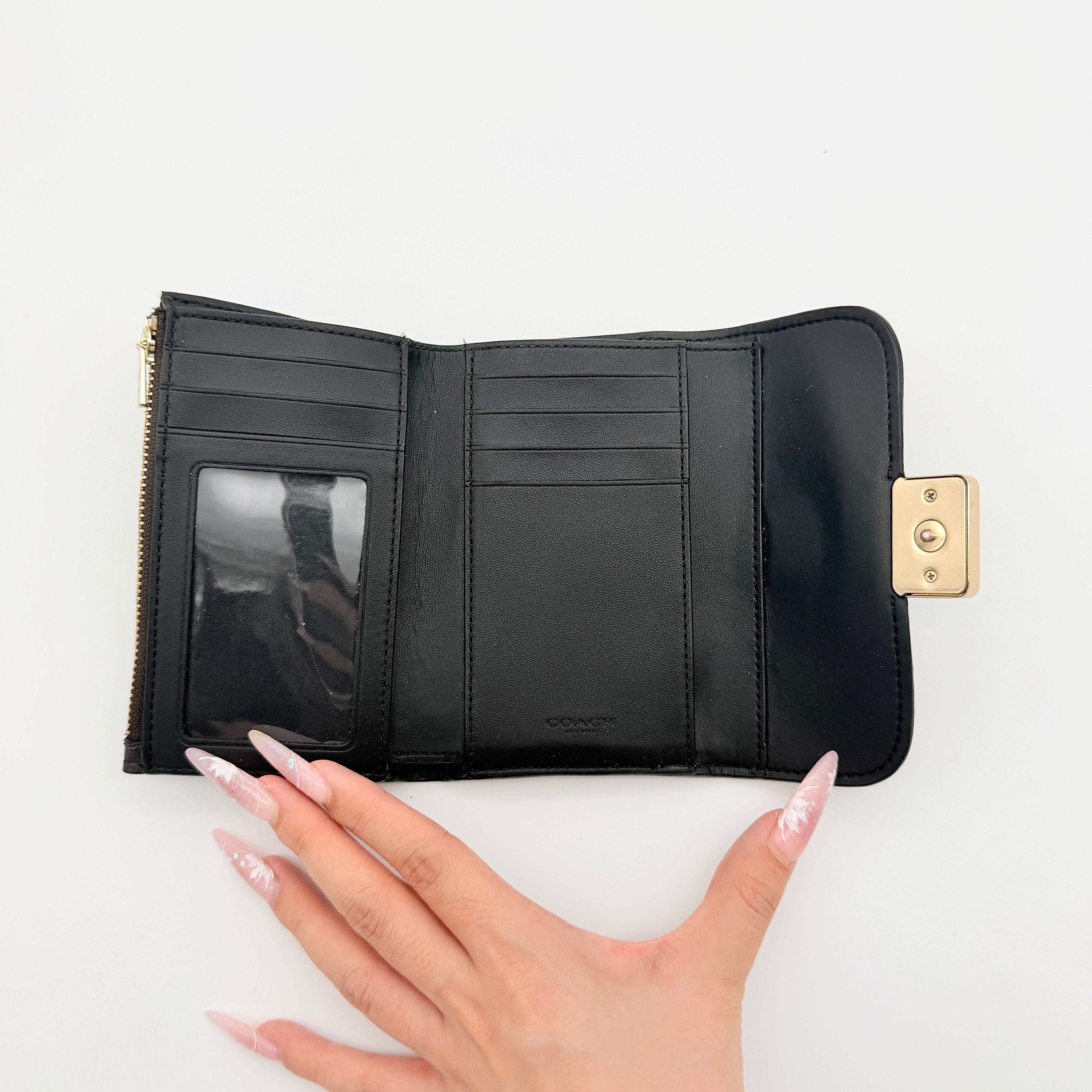 Coach Signature Medium Grace Wallet in brown and black with gold-tone carriage logo on the front.