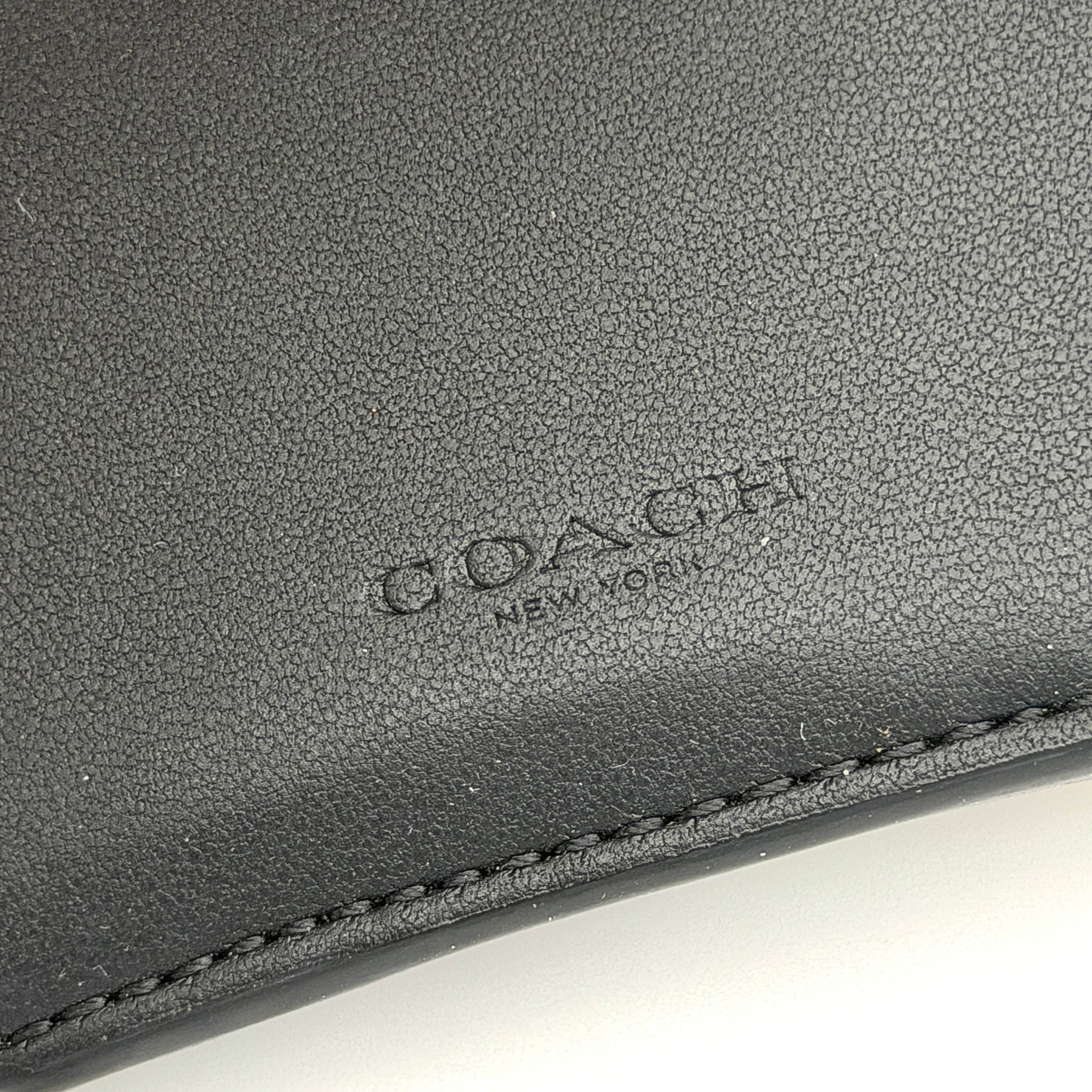 Coach Signature Medium Grace Wallet in brown and black with gold-tone carriage logo on the front.