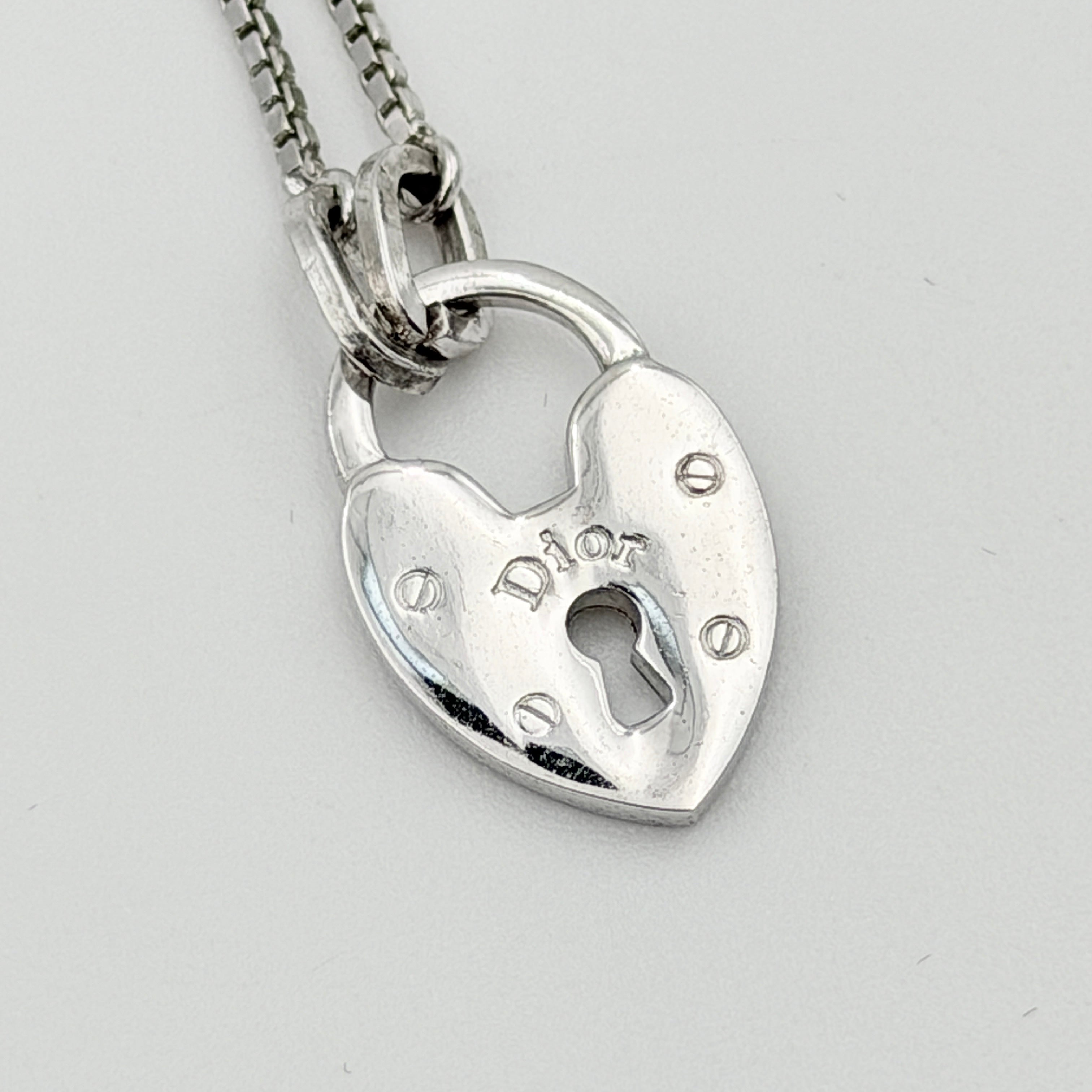 Dior Heart Padlock Necklace in polished silver-tone metal, featuring a heart-shaped padlock pendant on a slender box chain.