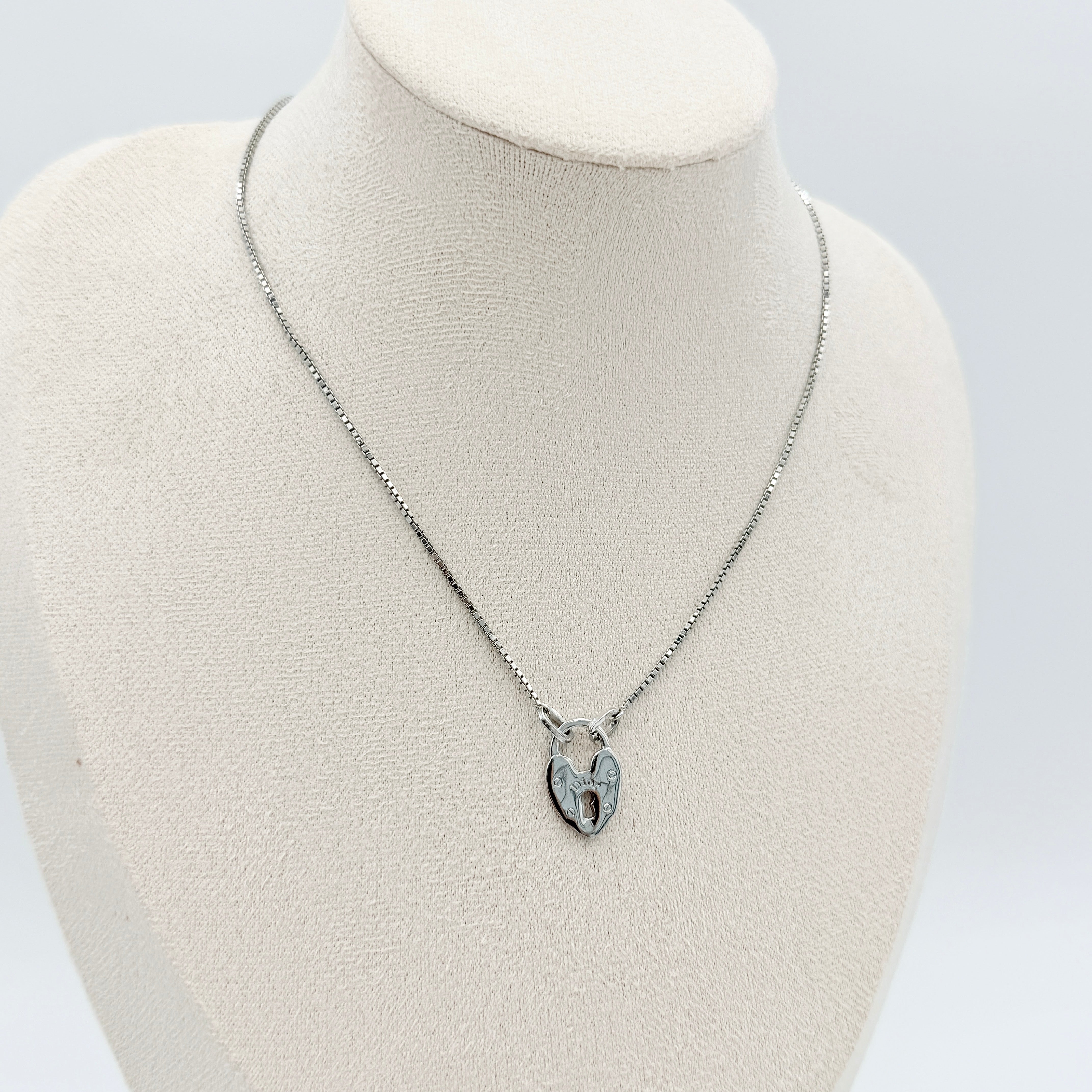 Dior Heart Padlock Necklace in polished silver-tone metal, featuring a heart-shaped padlock pendant on a slender box chain.