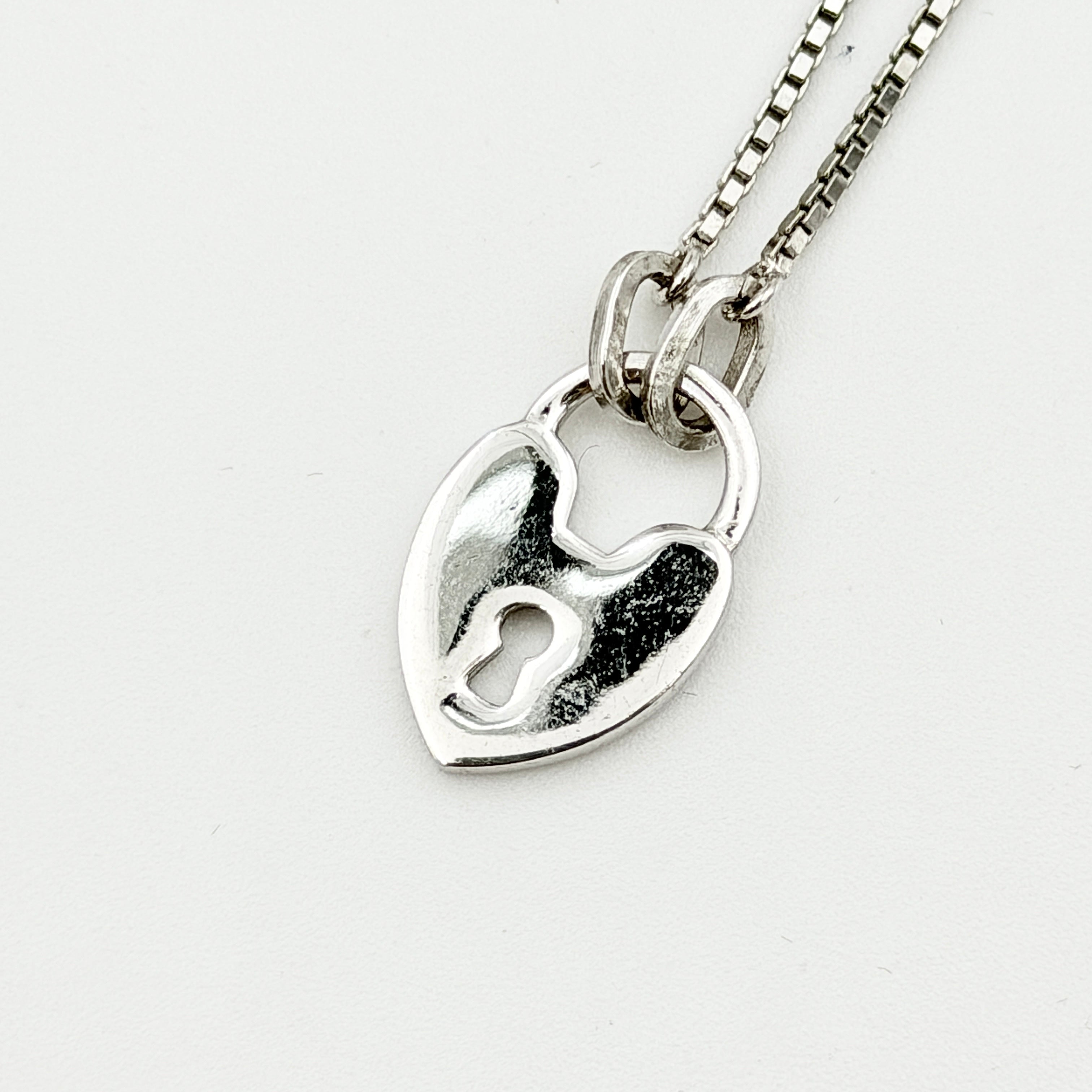 Dior Heart Padlock Necklace in polished silver-tone metal, featuring a heart-shaped padlock pendant on a slender box chain.