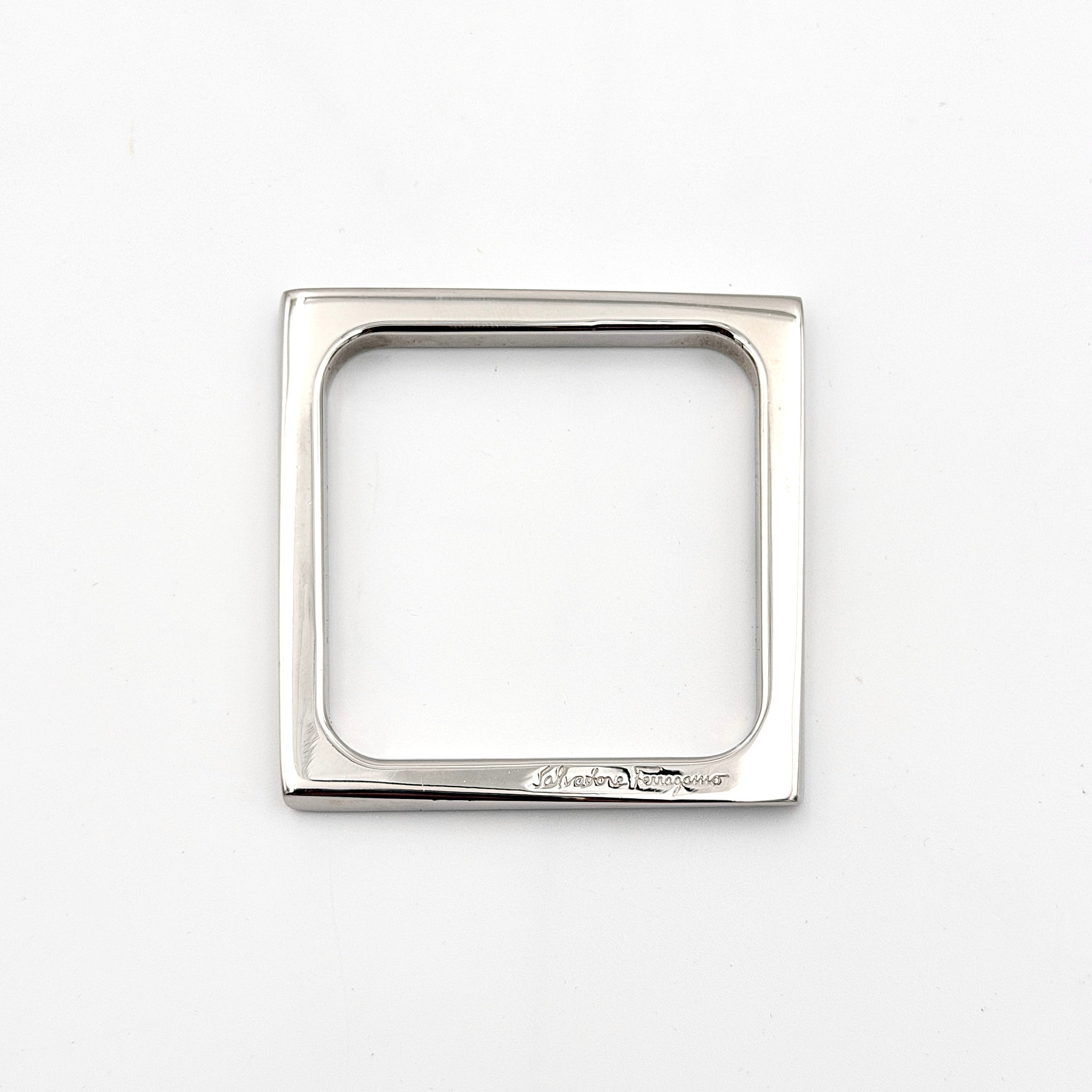 Salvatore Ferragamo square silver bangle bracelet with a crisp, minimalist silhouette and engraved logo.