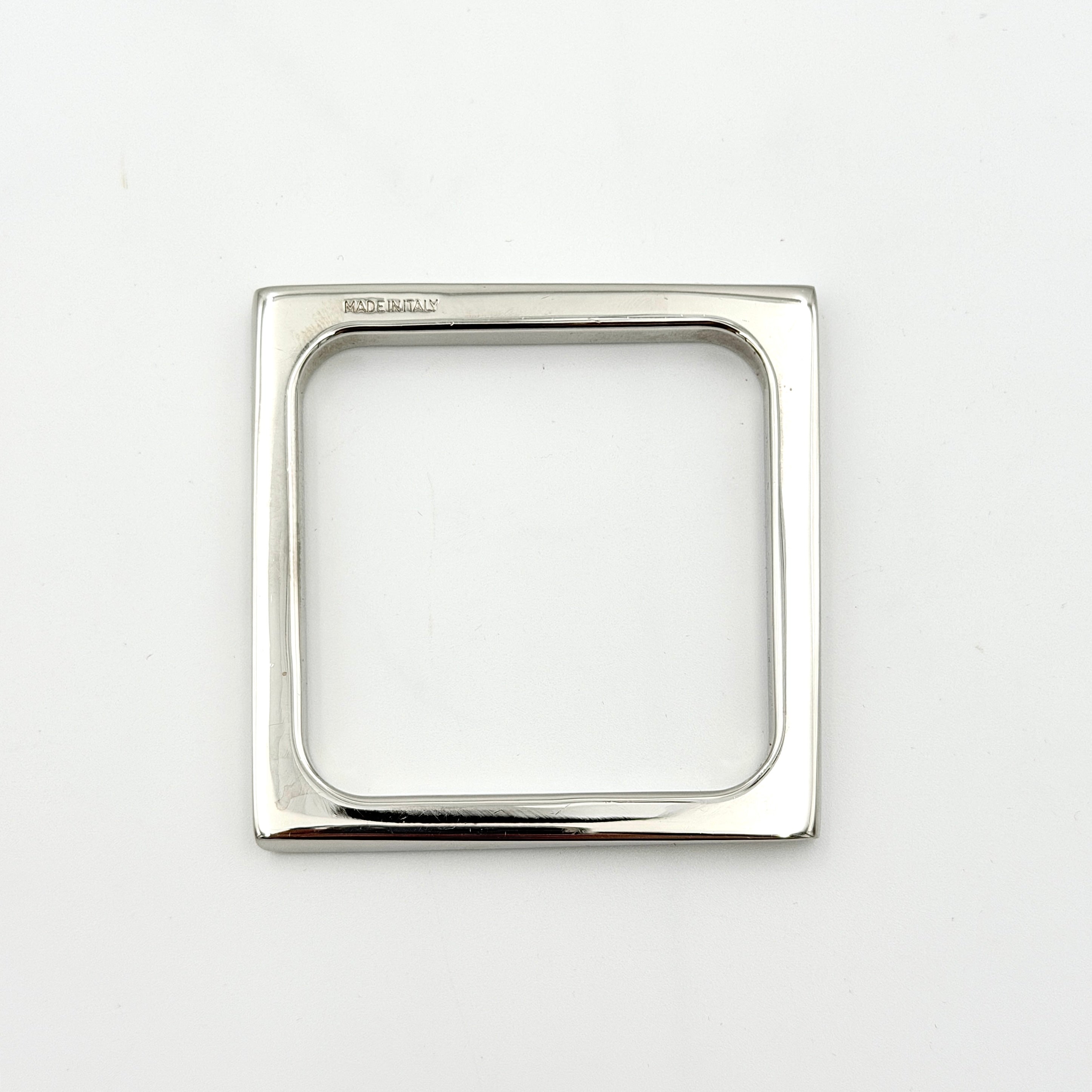 Salvatore Ferragamo square silver bangle bracelet with a crisp, minimalist silhouette and engraved logo.