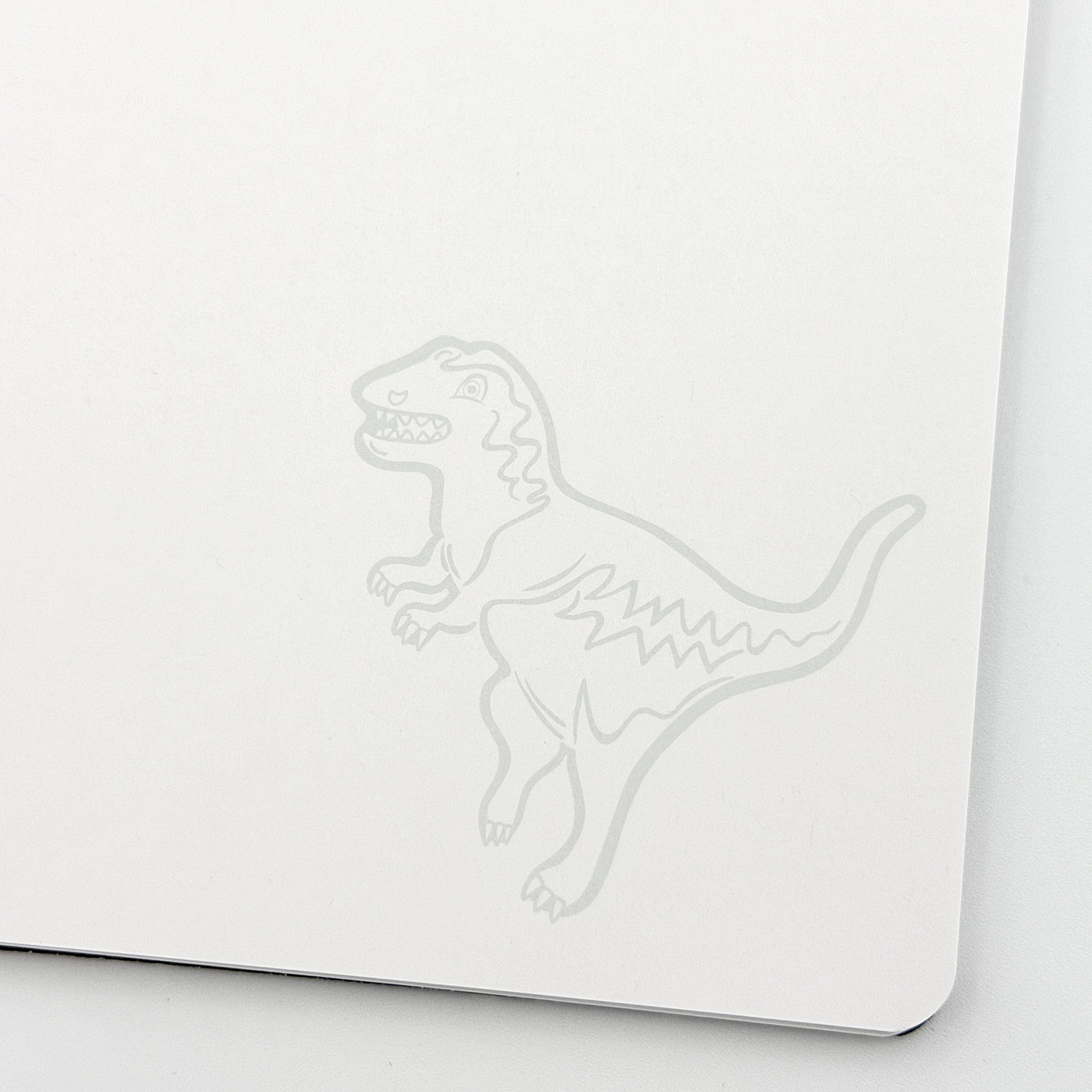Coach Rexy Journal Notebook in black featuring white Rexy dinosaur illustrations and a spiral binding.