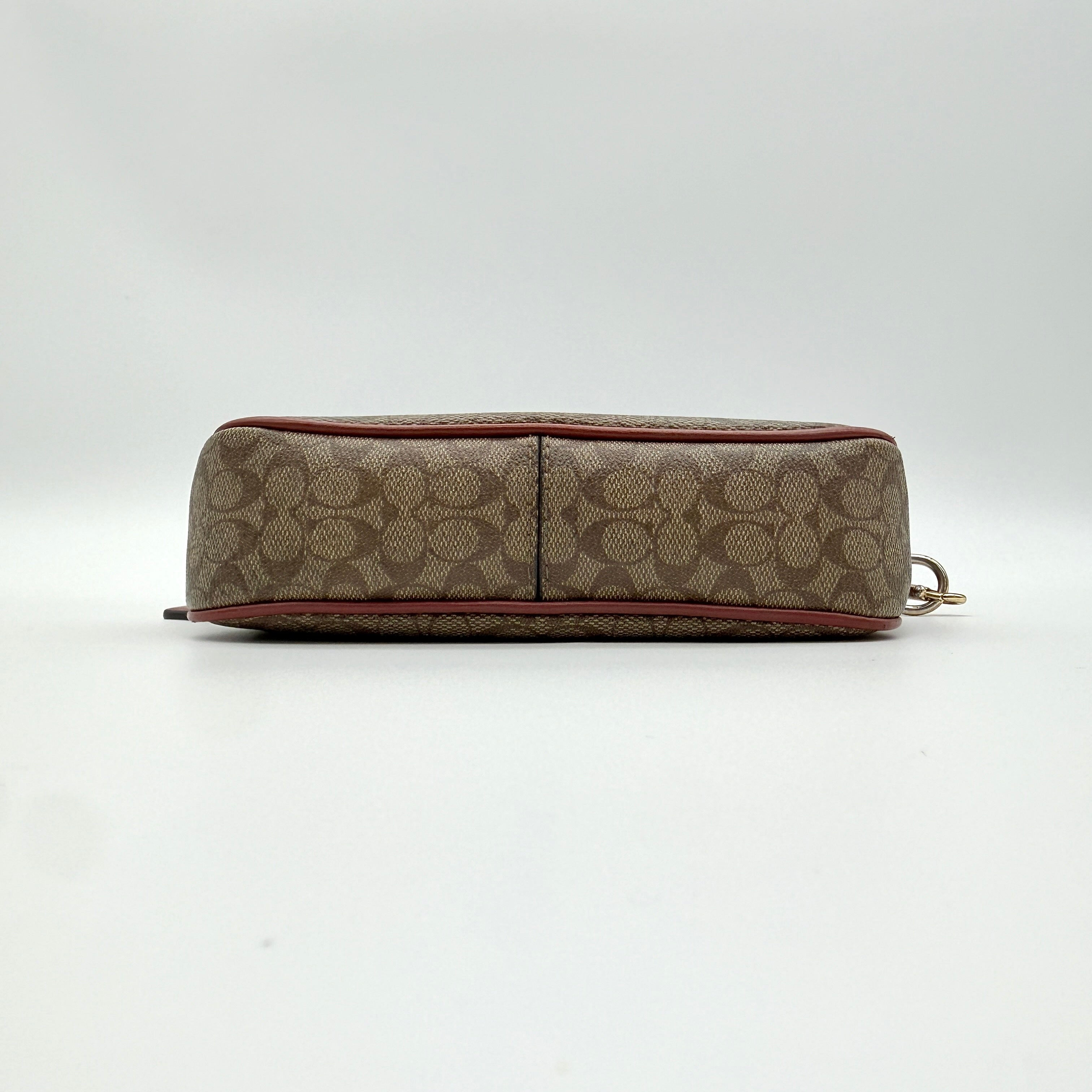 Coach Nolita 19 shoulder bag in beige monogram canvas with red leather trim and gold hardware, top view with strap.