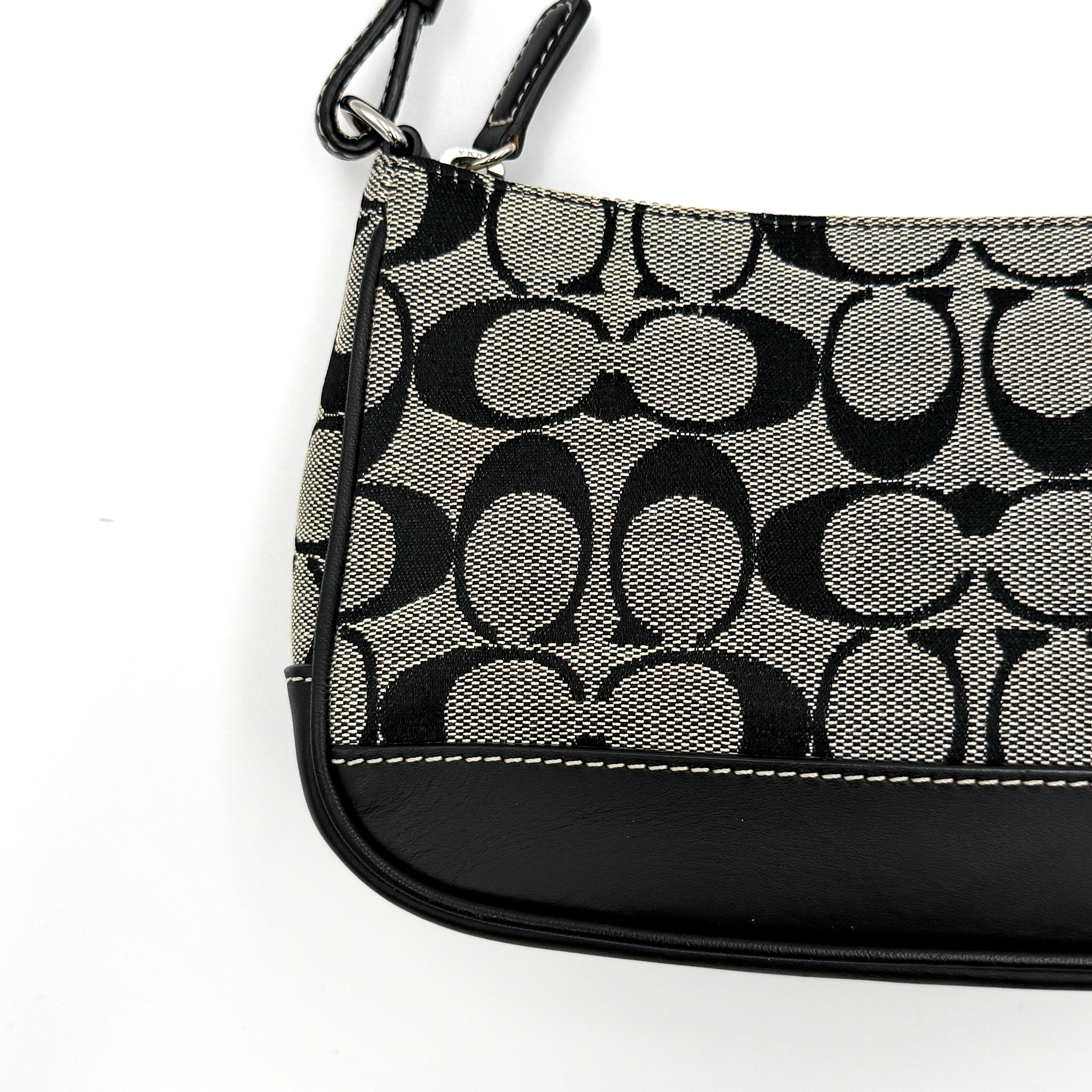 Coach Y2K Demi Shoulder Bag in black and grey monogram canvas with leather trim and a structured silhouette.