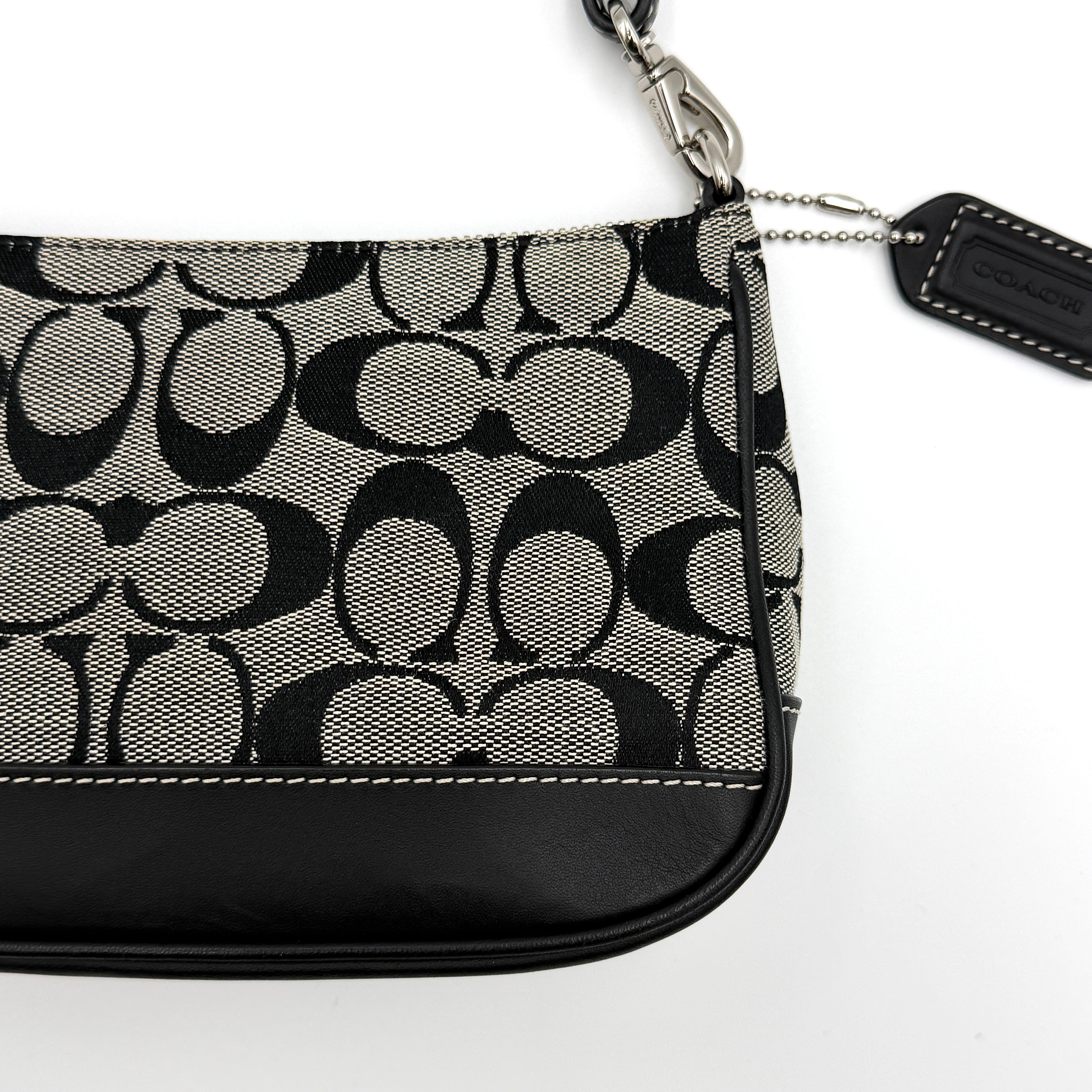 Coach Y2K Demi Shoulder Bag in black and grey monogram canvas with leather trim and a structured silhouette.