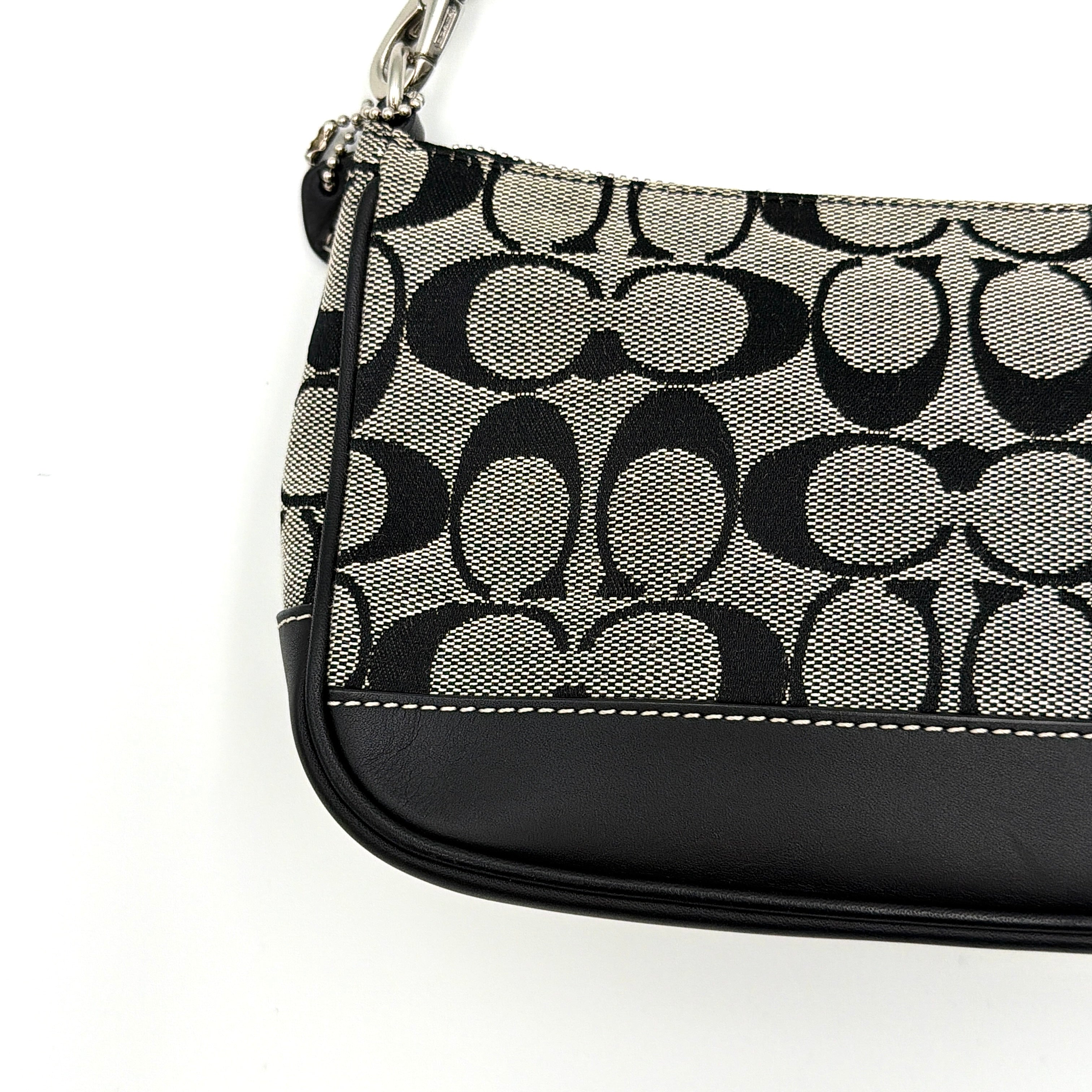 Coach Y2K Demi Shoulder Bag in black and grey monogram canvas with leather trim and a structured silhouette.