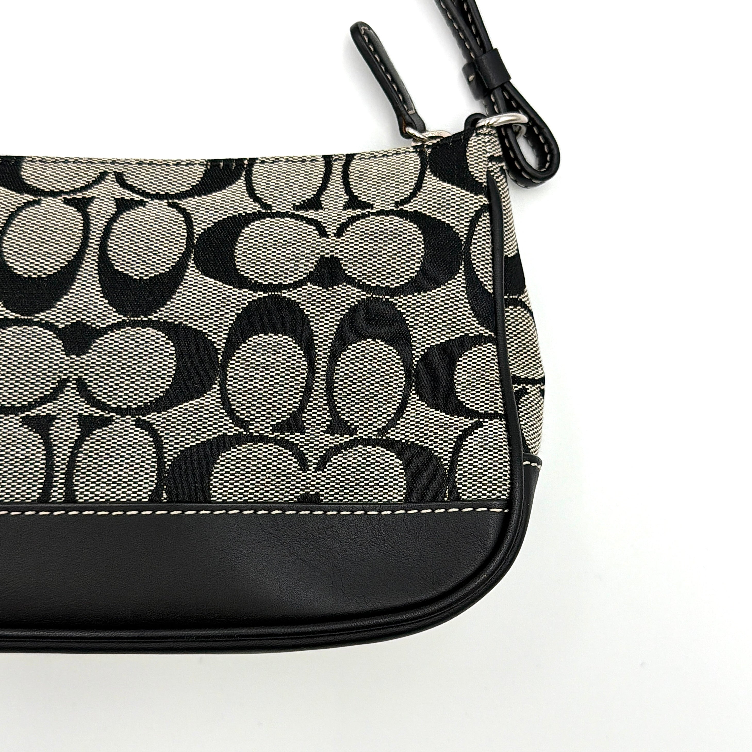 Coach Y2K Demi Shoulder Bag in black and grey monogram canvas with leather trim and a structured silhouette.