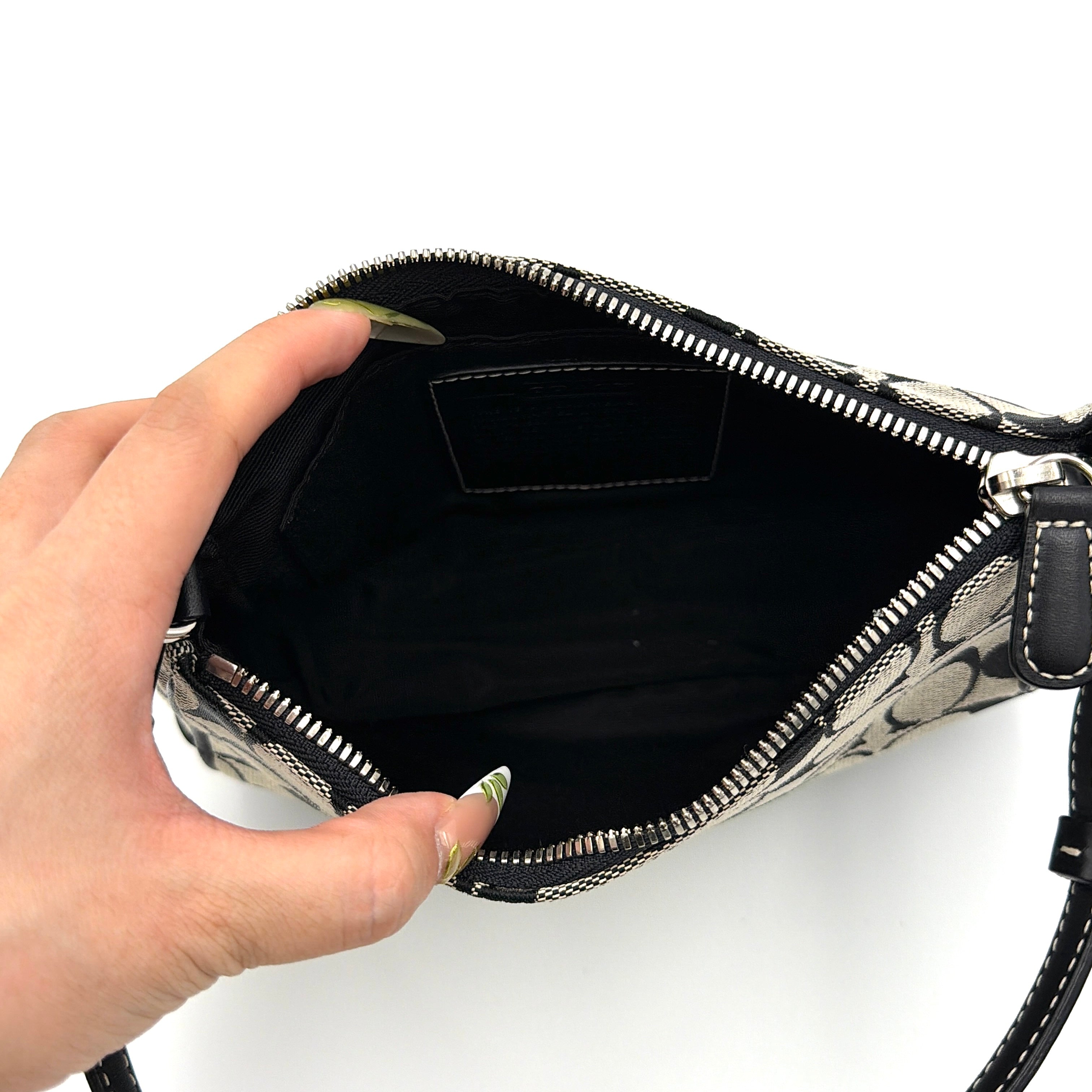 Coach Y2K Demi Shoulder Bag in black and grey monogram canvas with leather trim and a structured silhouette.
