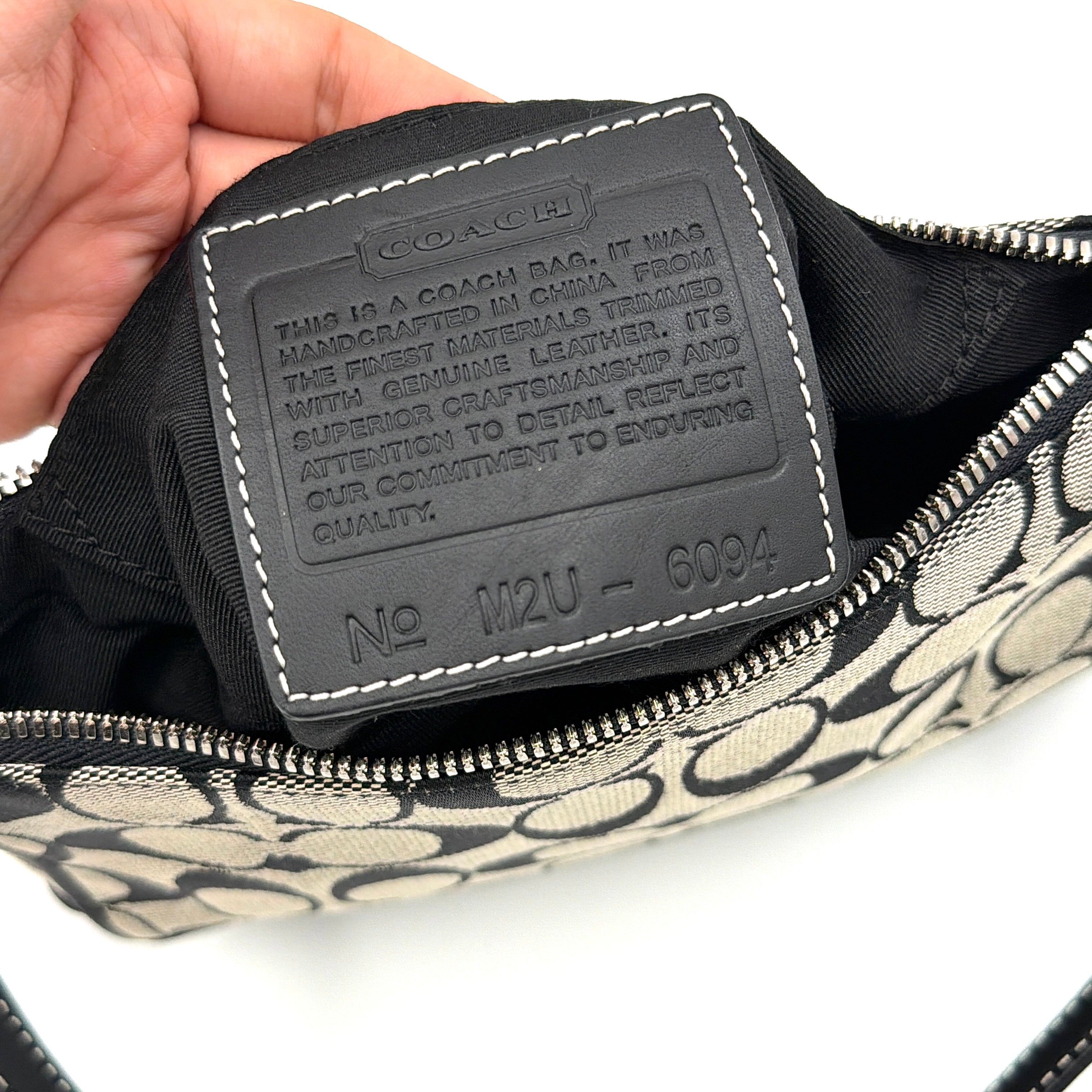Coach Y2K Demi Shoulder Bag in black and grey monogram canvas with leather trim and a structured silhouette.