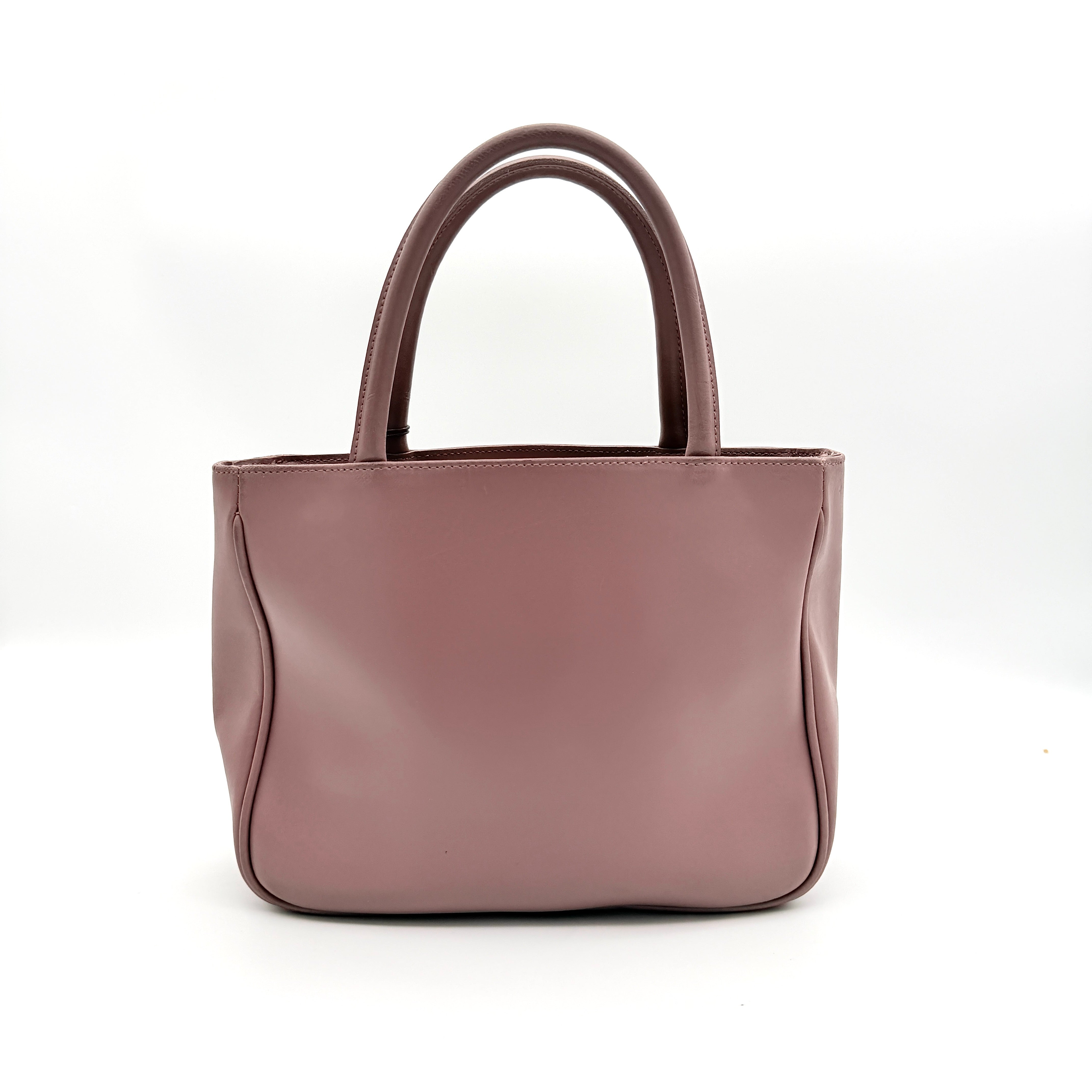 Furla 2Way Leather Handbag in pink with top handles, gold-tone charm, and a detachable strap, photographed on a white background.