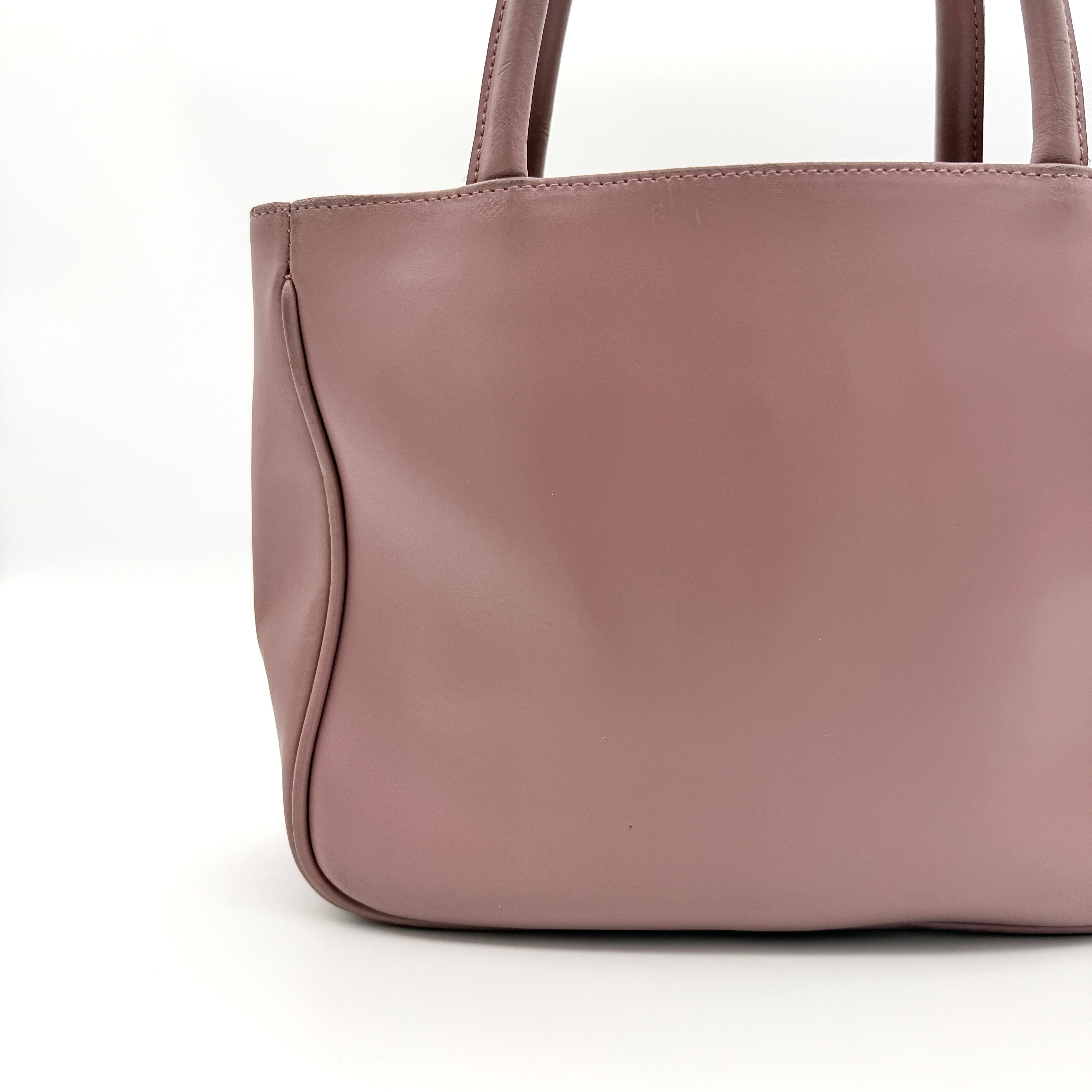 Furla 2Way Leather Handbag in pink with top handles, gold-tone charm, and a detachable strap, photographed on a white background.