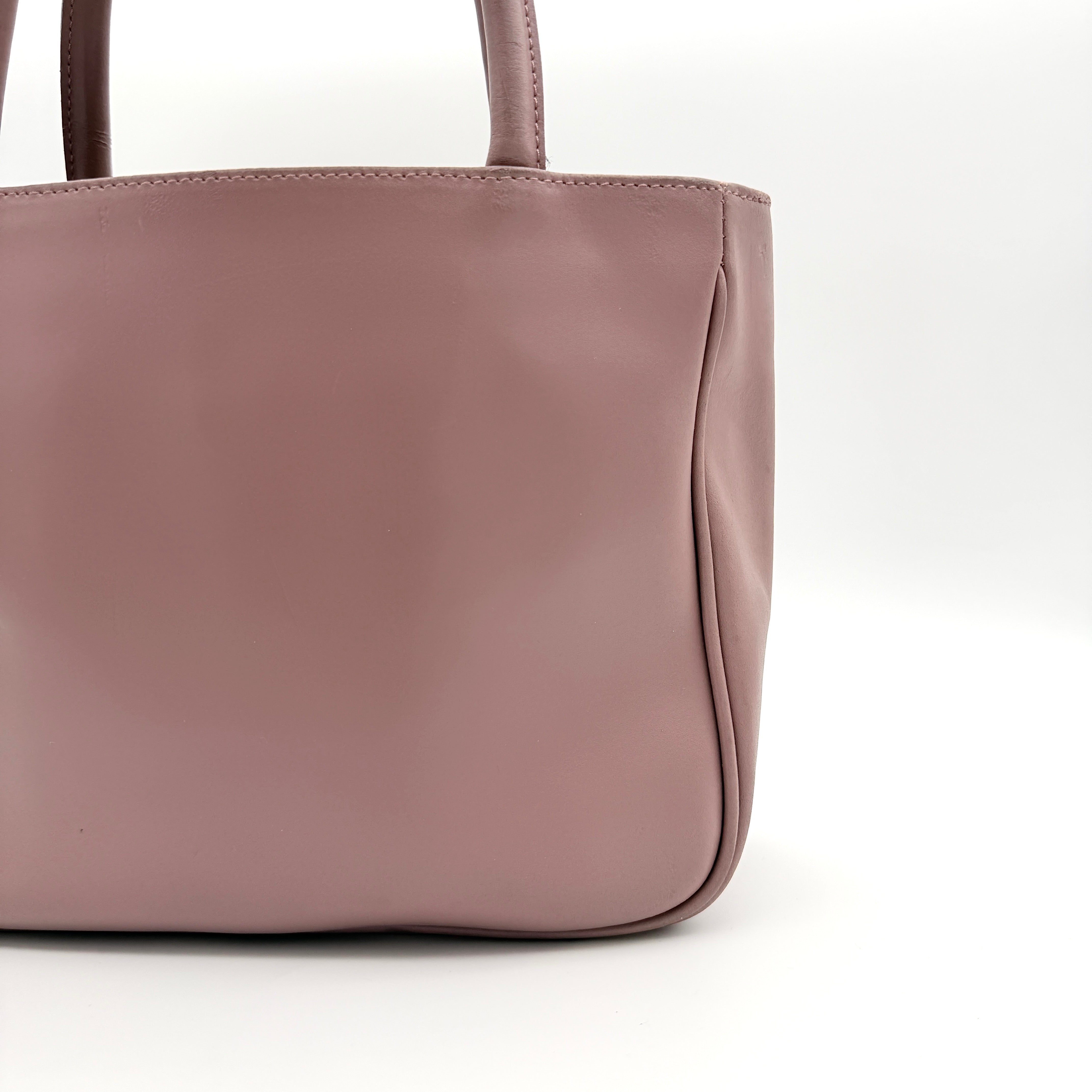 Furla 2Way Leather Handbag in pink with top handles, gold-tone charm, and a detachable strap, photographed on a white background.