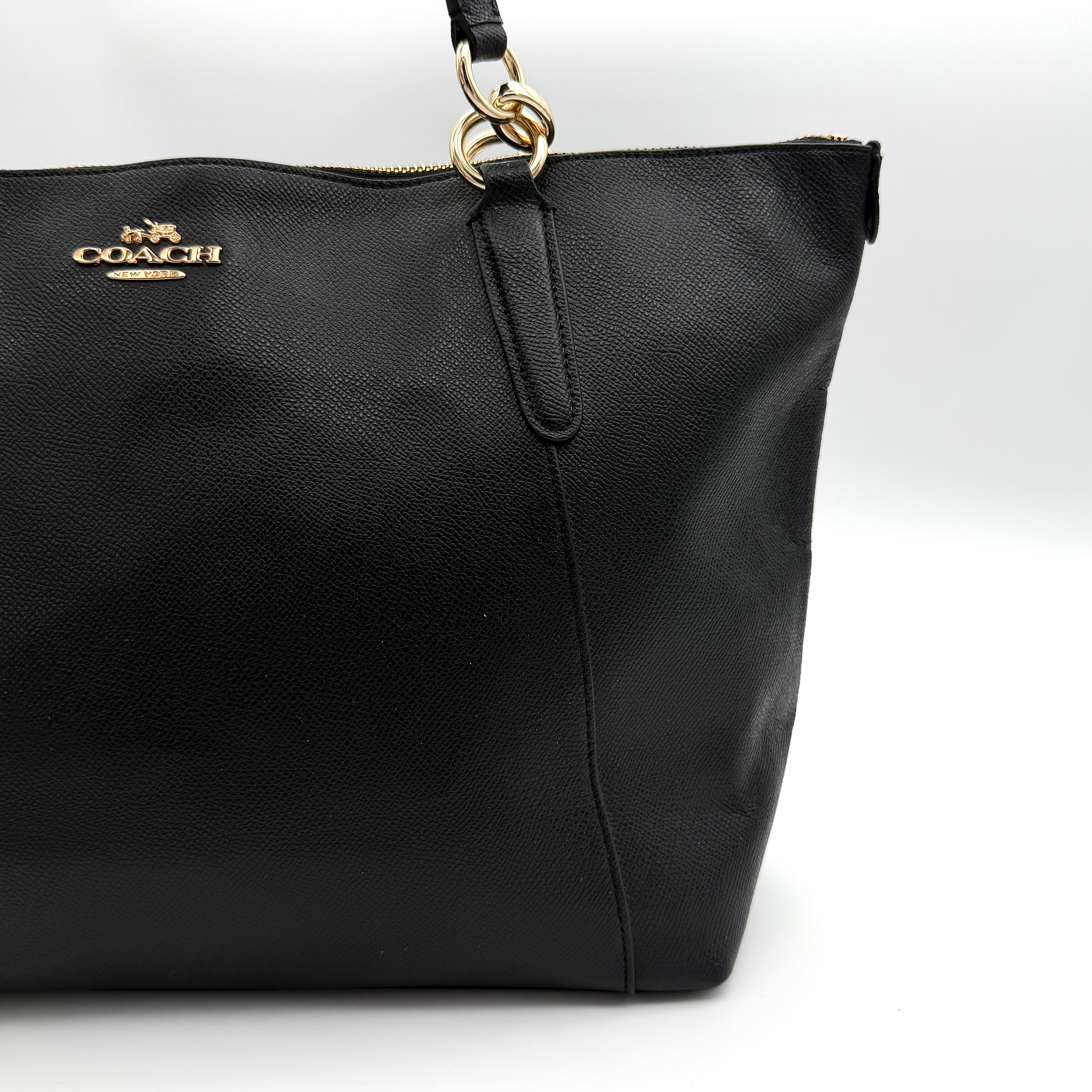 Coach Ava Leather Tote Bag in black pebbled leather with gold-tone hardware and dual top handles.