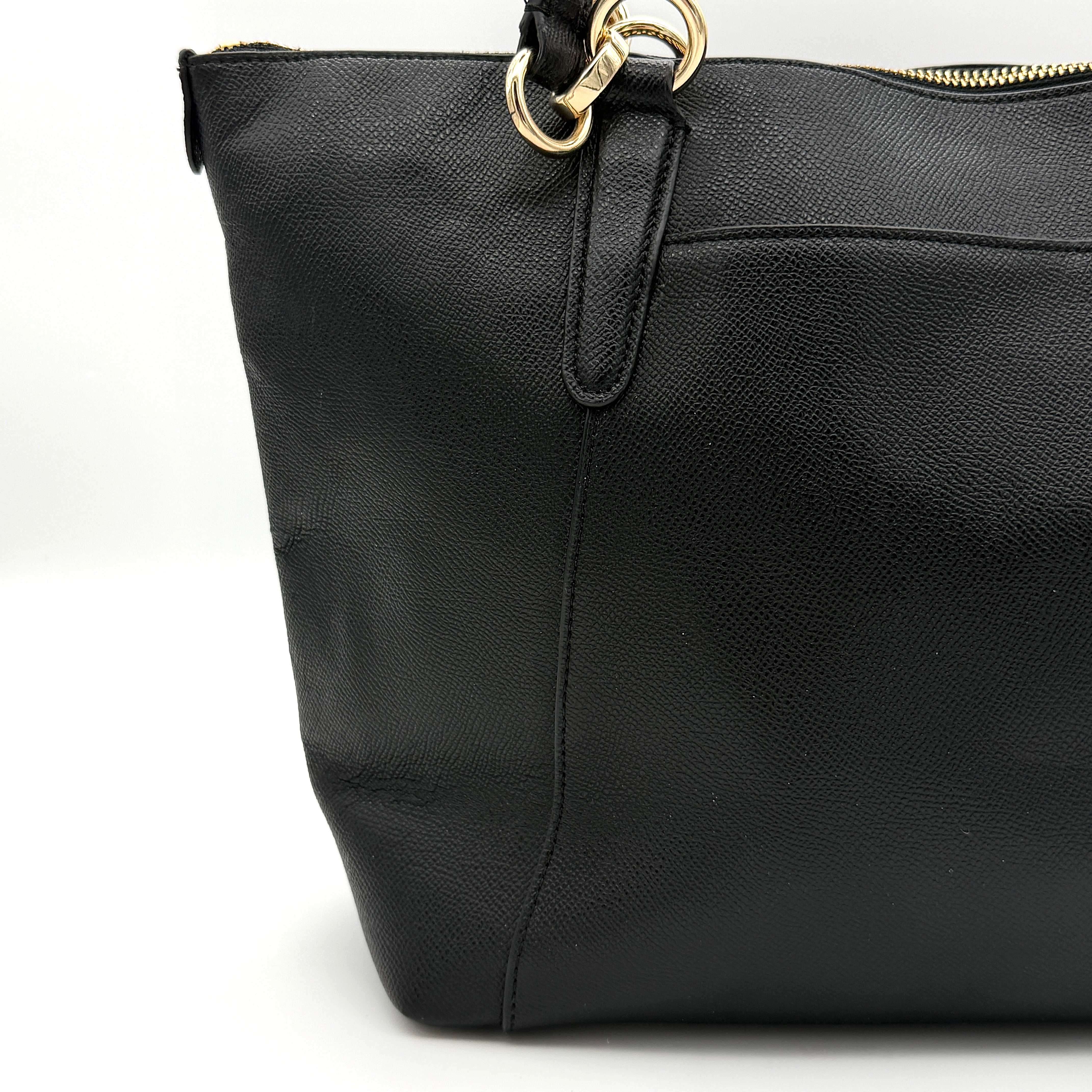 Coach Ava Leather Tote Bag in black pebbled leather with gold-tone hardware and dual top handles.