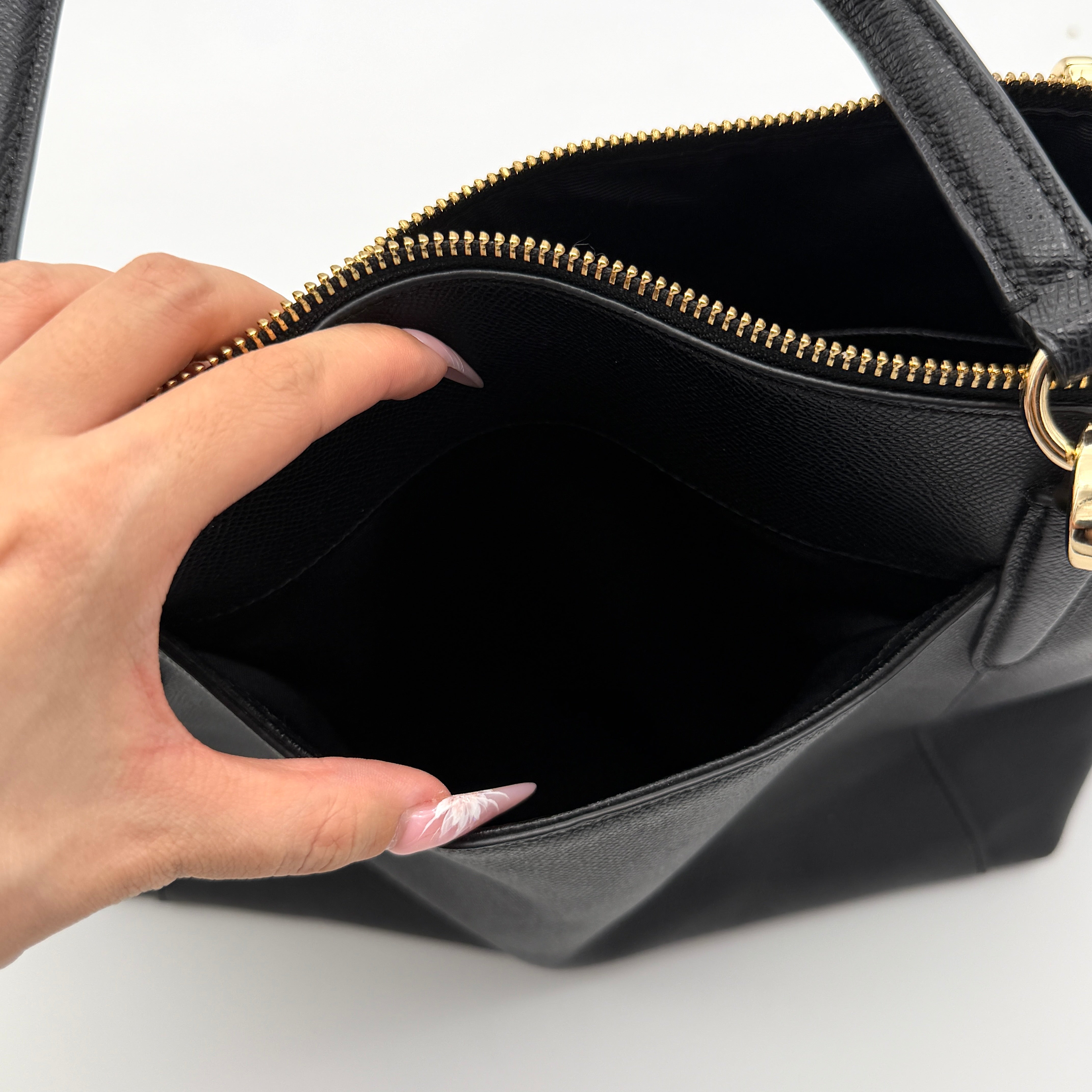 Coach Ava Leather Tote Bag in black pebbled leather with gold-tone hardware and dual top handles.