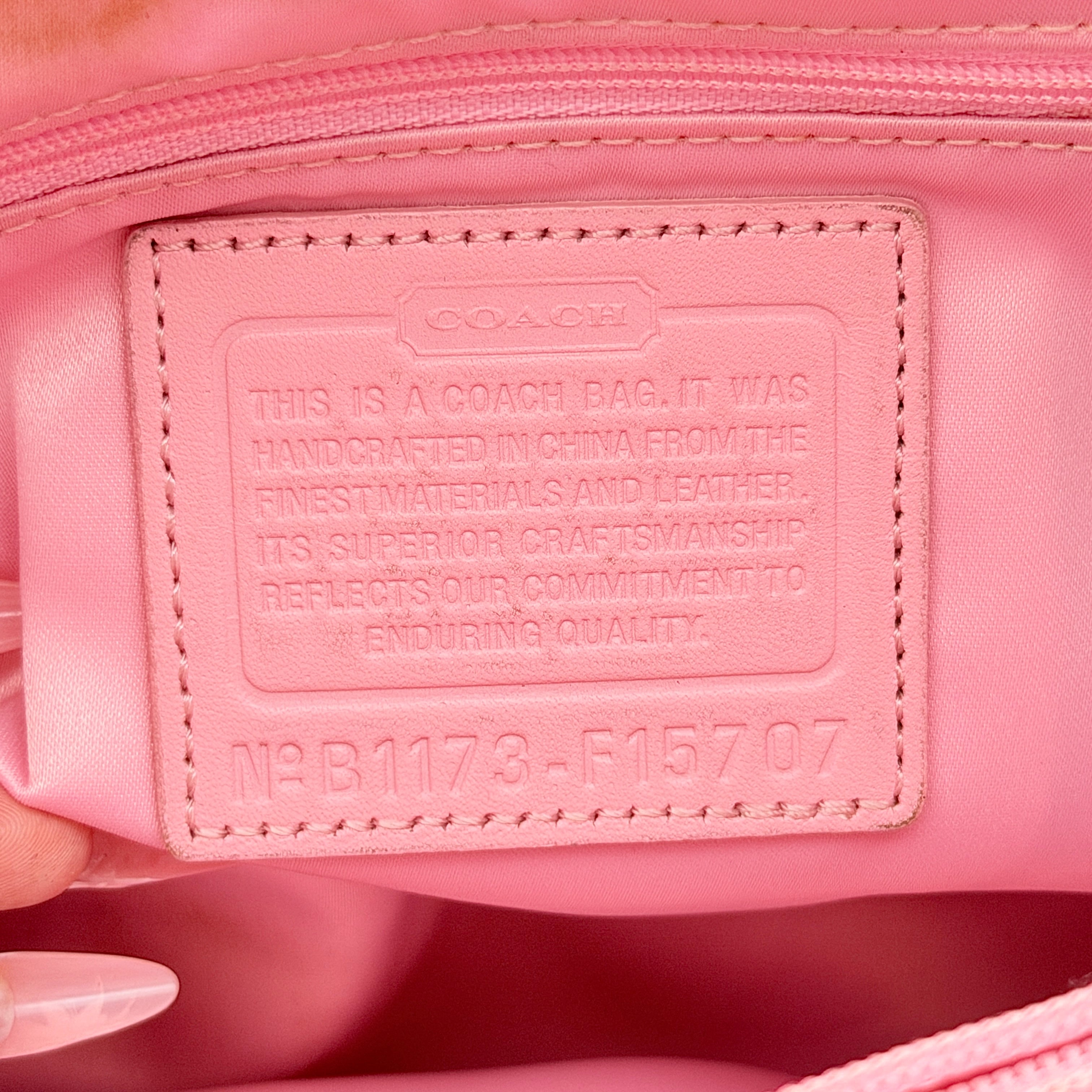 Coach Signature Penelope Shoulder Bag in pastel pink jacquard canvas with leather trim and silver-tone hardware.
