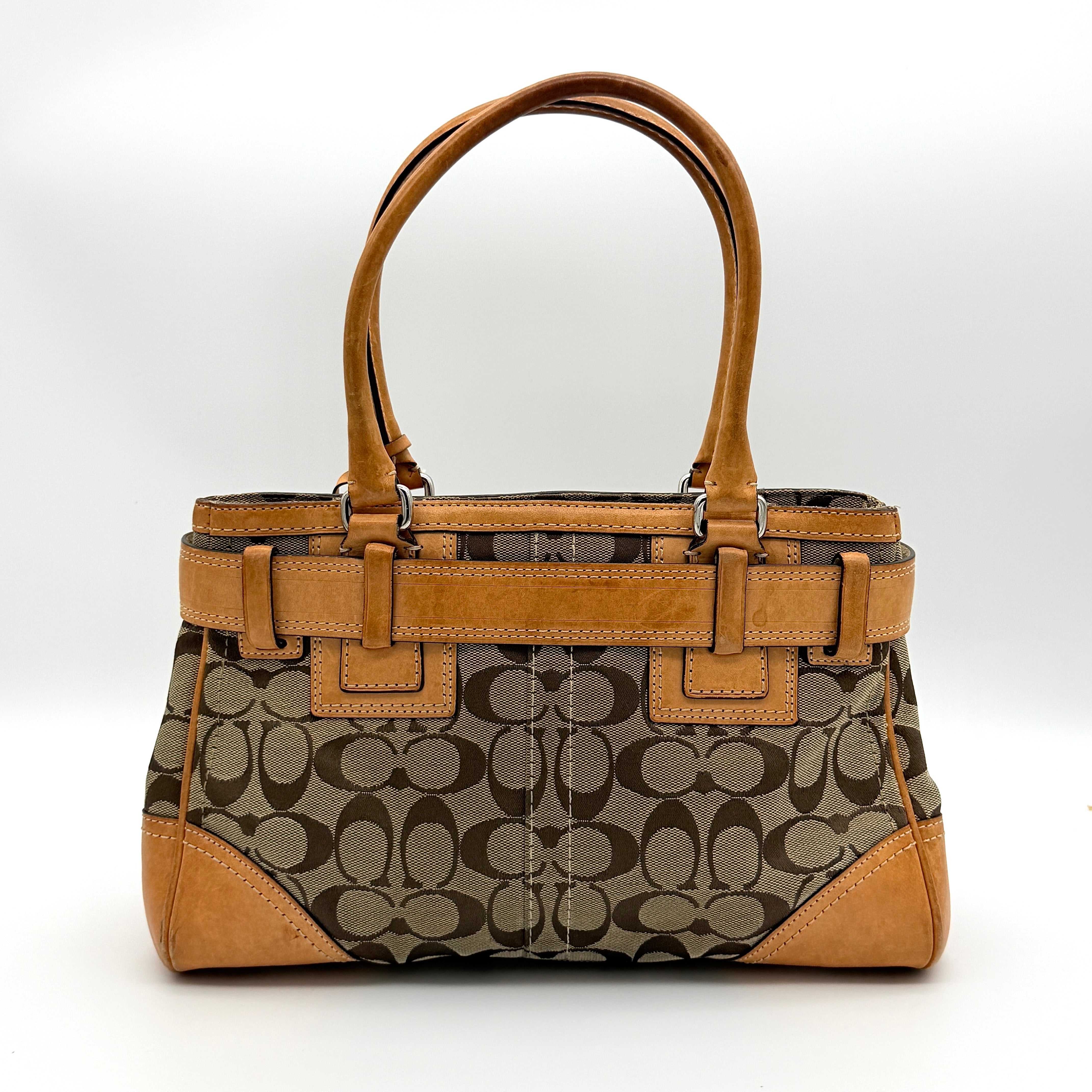 Coach Signature Hampton Carryall shoulder bag in beige monogram canvas and tan leather with silver-tone hardware and double handles.
