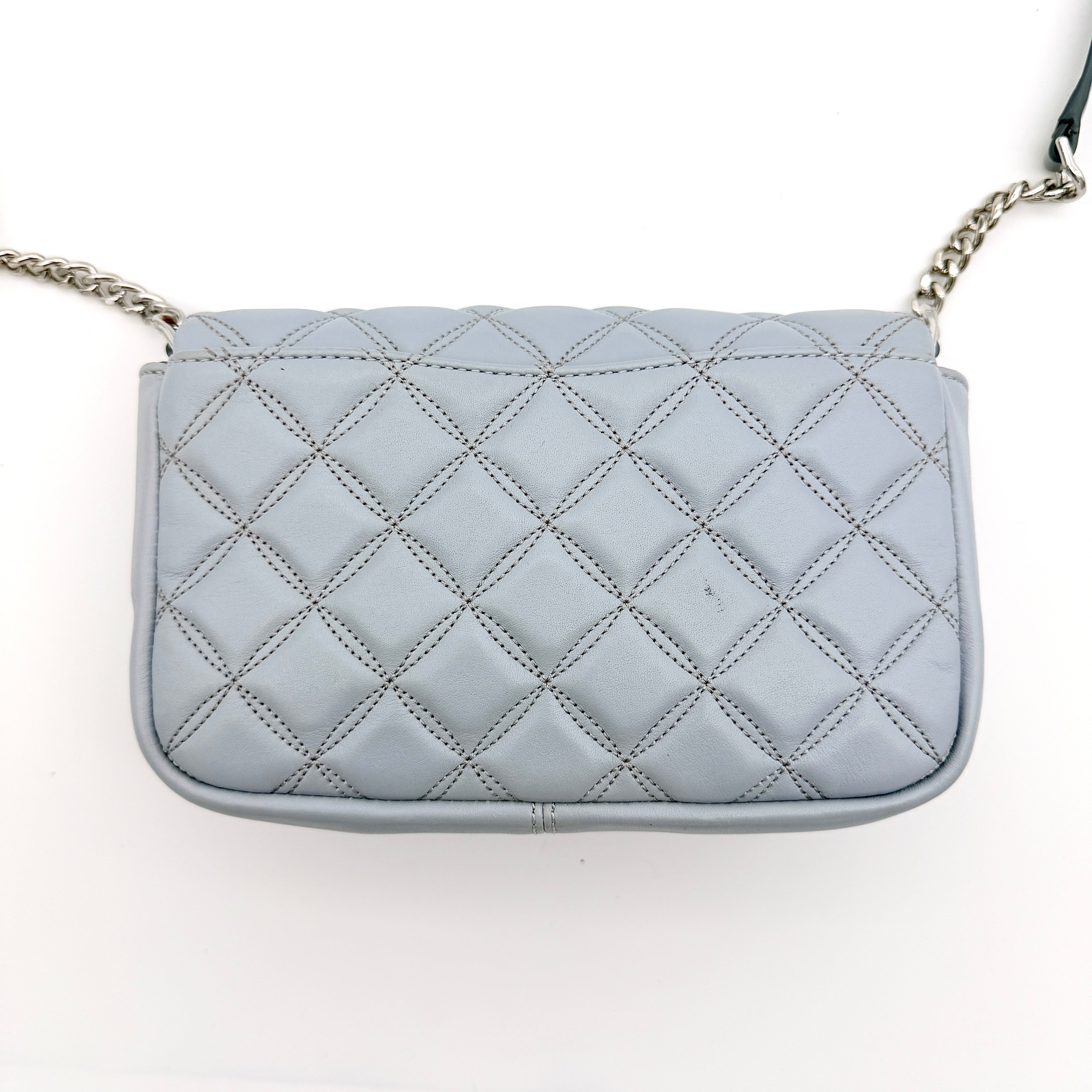 Kate Spade Natalia Flap Crossbody in light blue quilted leather with a silver chain and turn-lock detail.