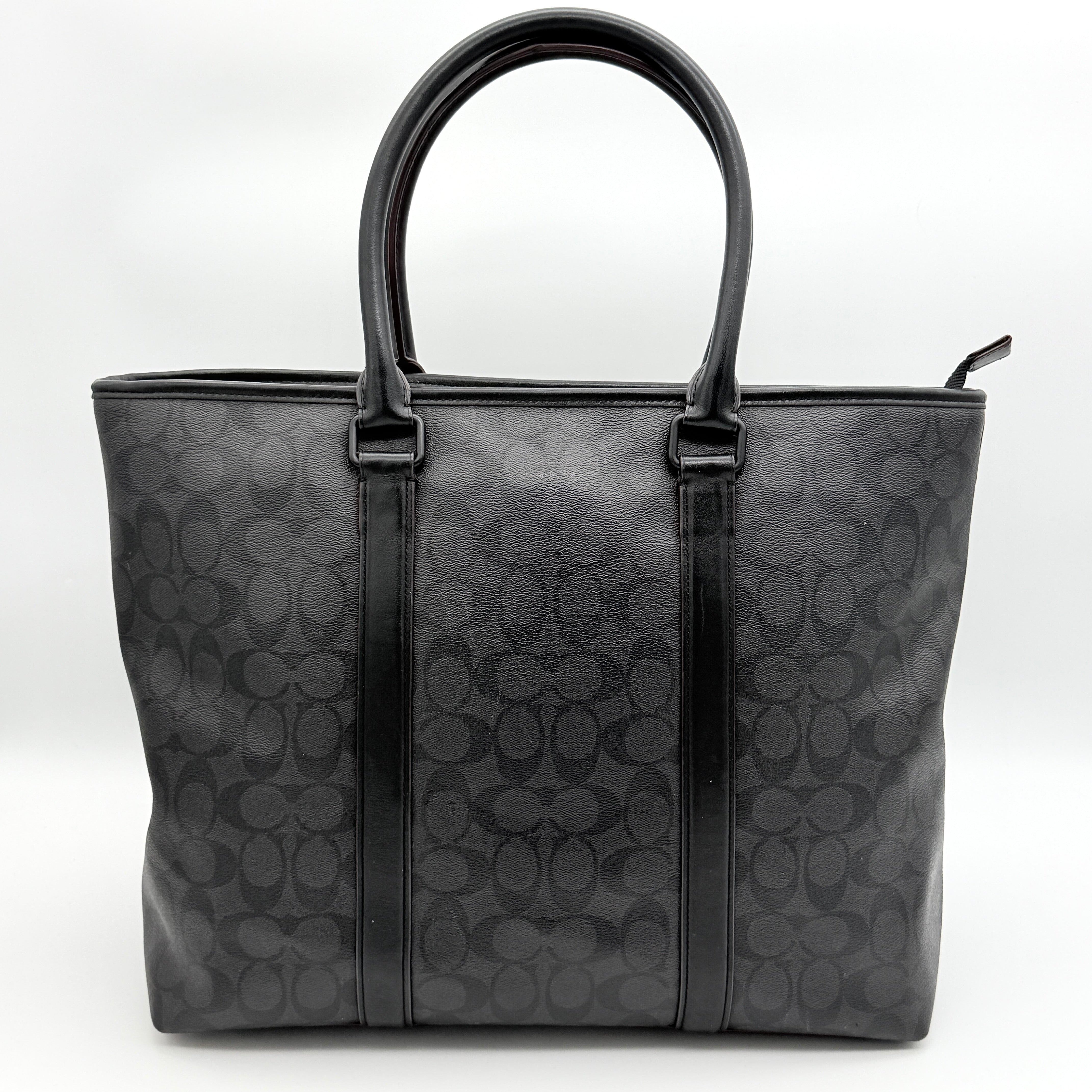 Coach Perry Business Tote in charcoal black signature canvas with double handles and detachable strap, shown upright against a white background.