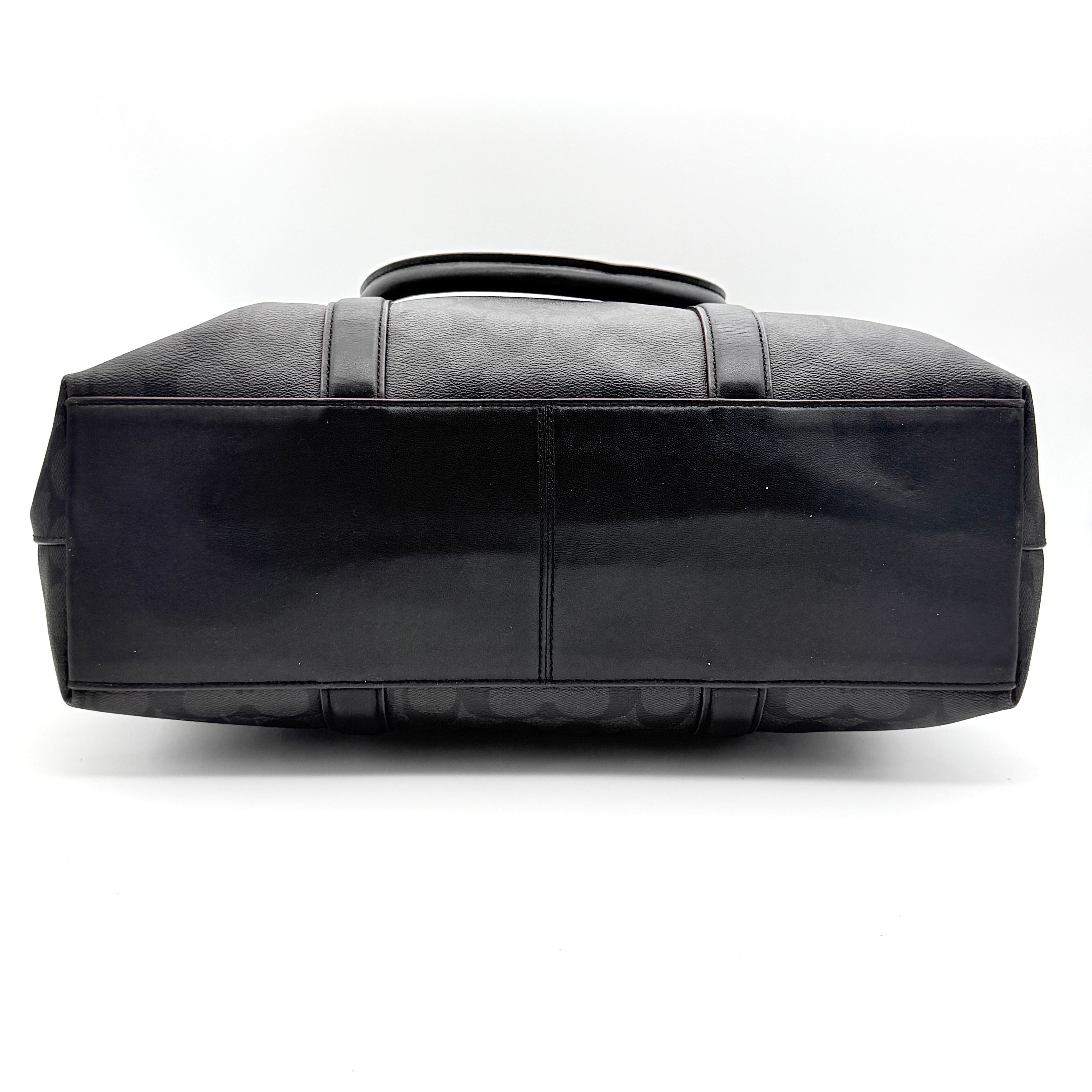 Coach Perry Business Tote in charcoal black signature canvas with double handles and detachable strap, shown upright against a white background.