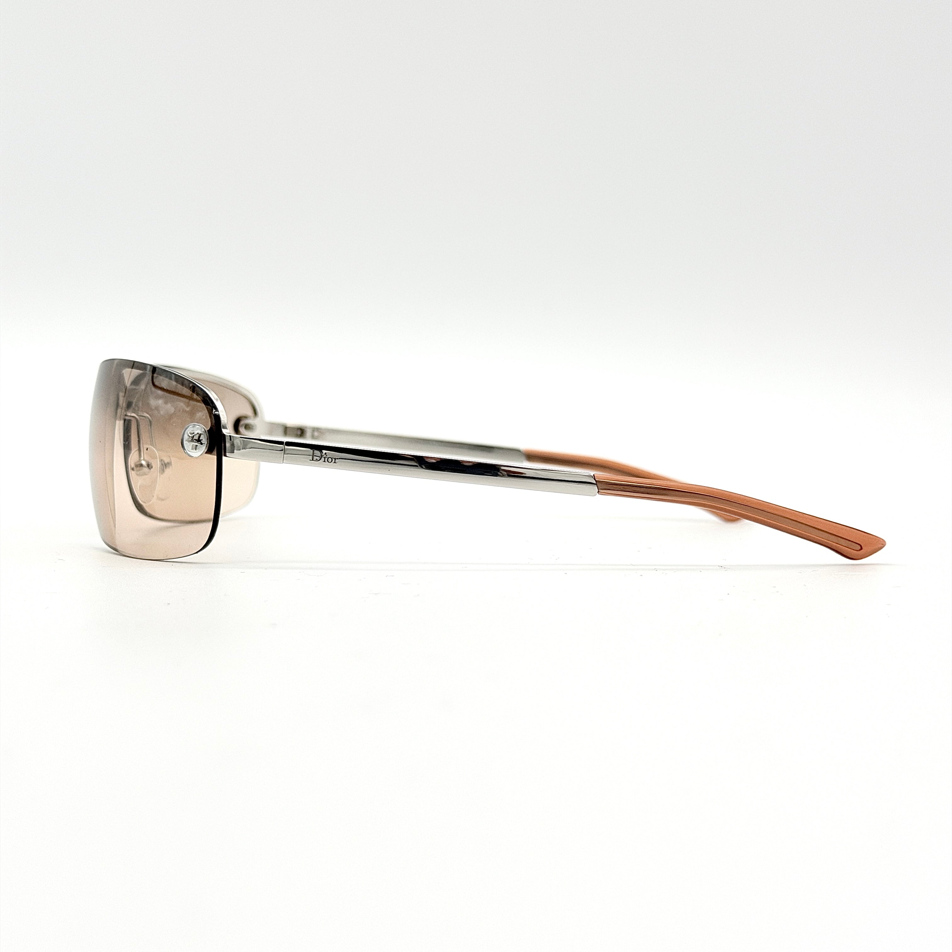 Dior Adiorable 3/L sunglasses in silver with brown gradient lenses, displayed in front of the Dior hard case.