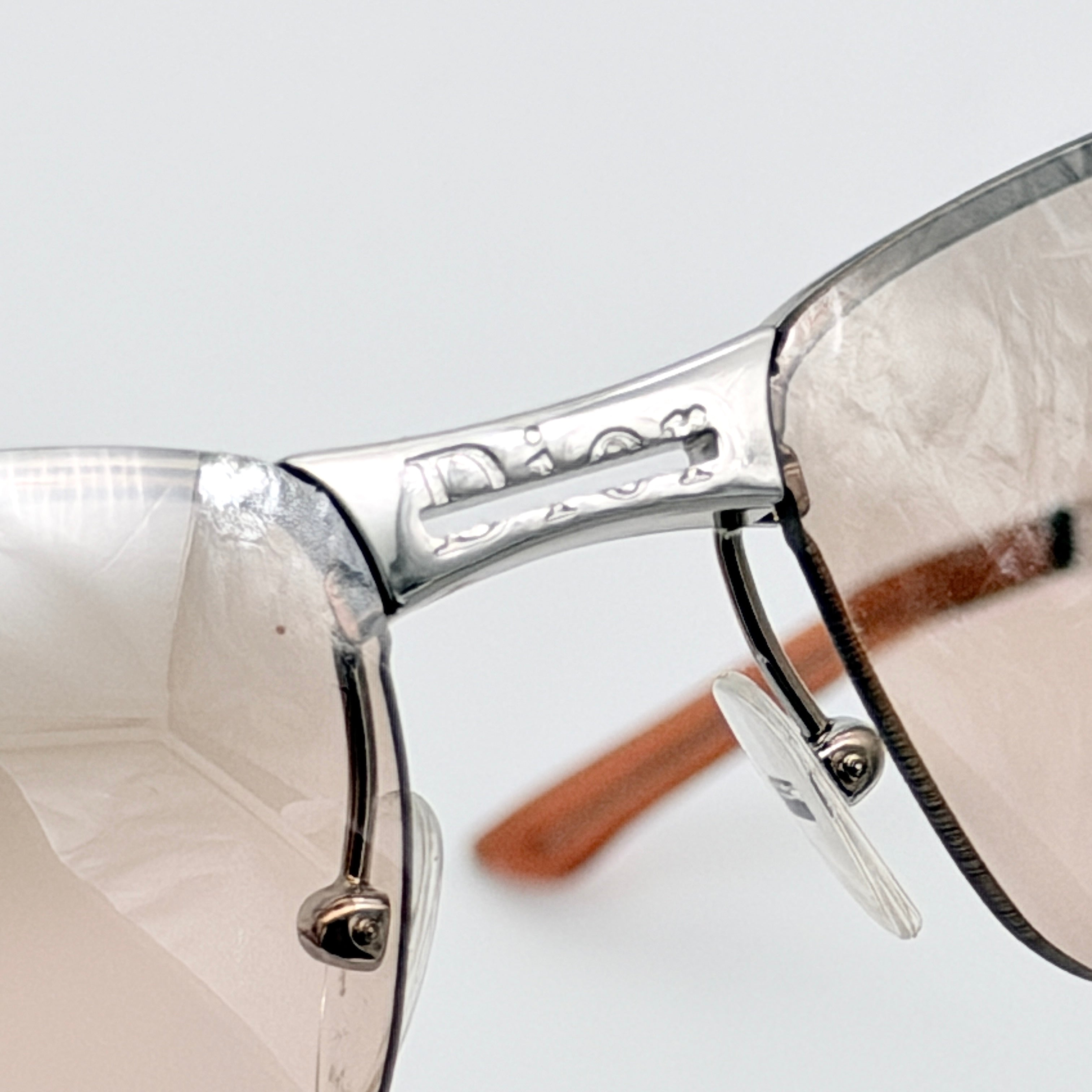 Dior Adiorable 3/L sunglasses in silver with brown gradient lenses, displayed in front of the Dior hard case.