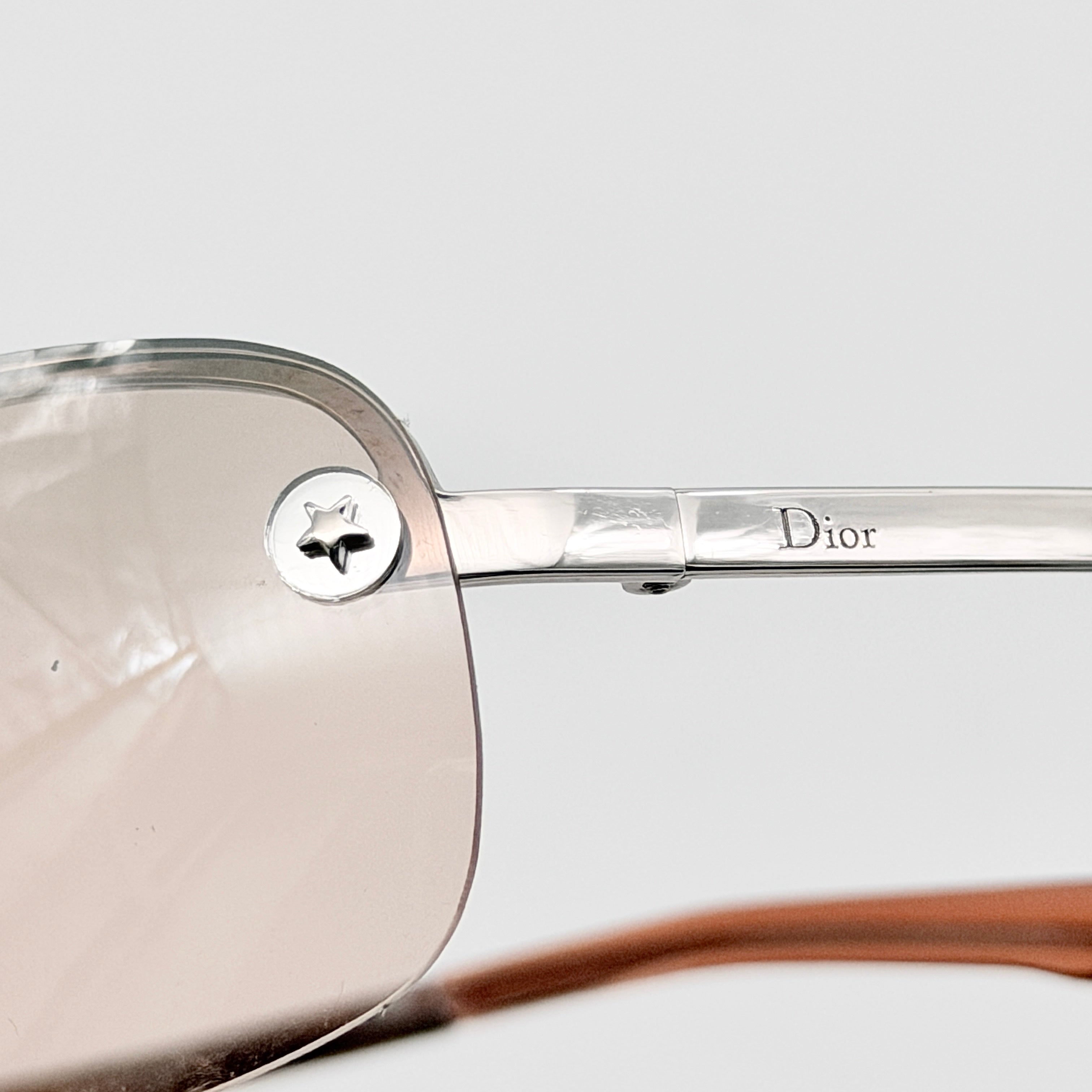 Dior Adiorable 3/L sunglasses in silver with brown gradient lenses, displayed in front of the Dior hard case.