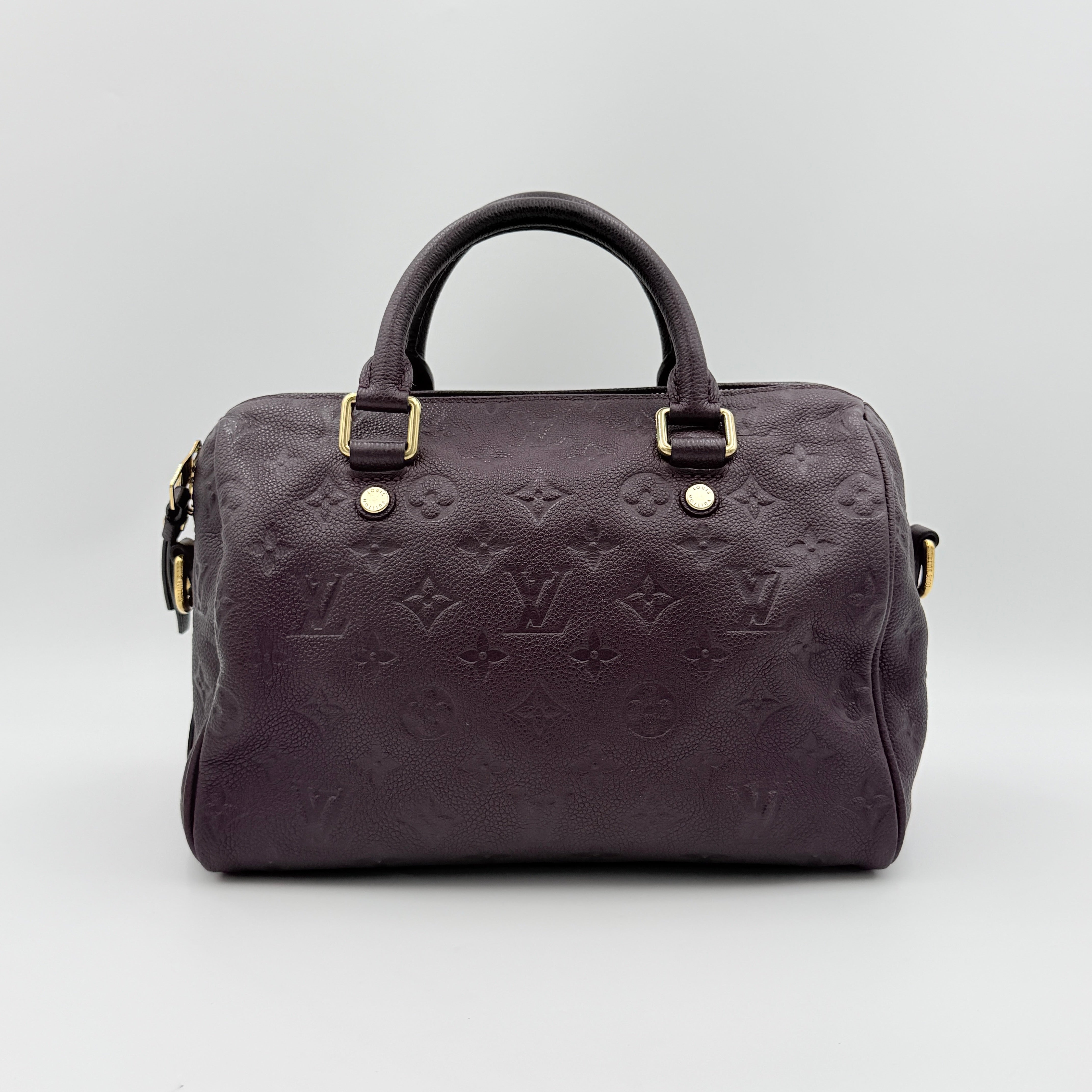 Louis Vuitton 2Way Monogram Empreinte Speedy Bandoulière 25 in deep purple grained leather with gold-tone hardware and detachable strap.