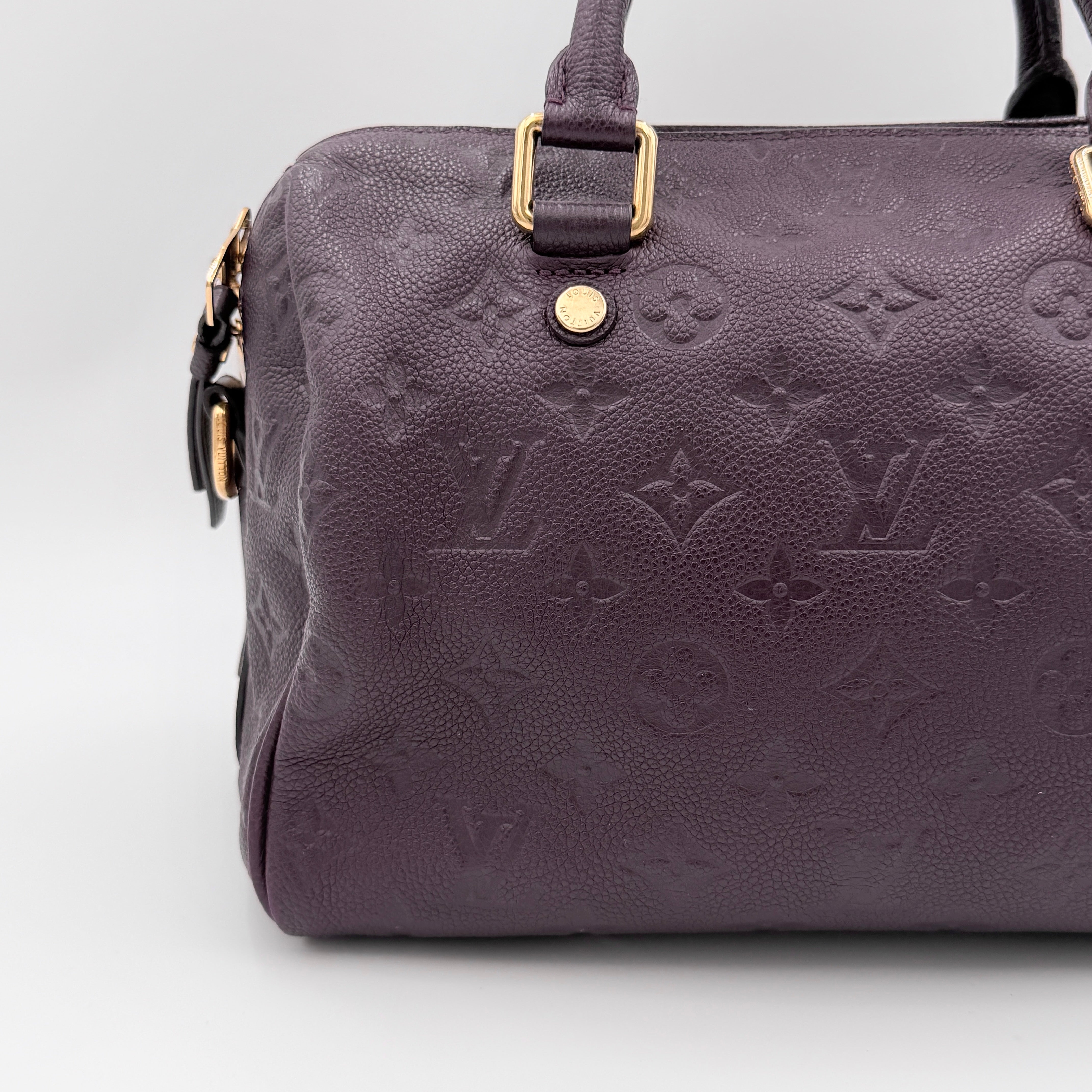 Louis Vuitton 2Way Monogram Empreinte Speedy Bandoulière 25 in deep purple grained leather with gold-tone hardware and detachable strap.