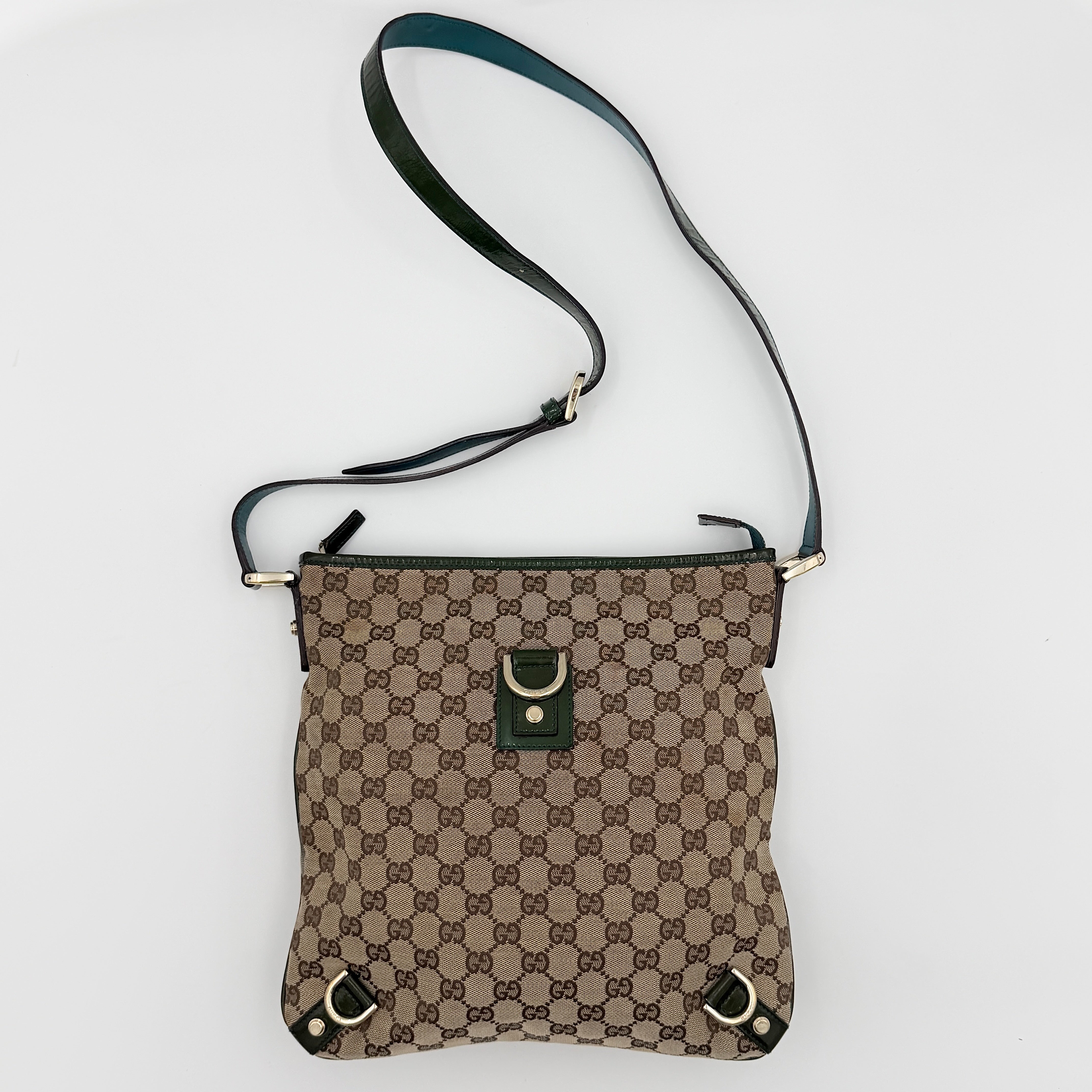 Gucci GG Monogram Abbey D Ring Crossbody Bag in beige canvas with green leather trim and gold-tone hardware, featuring an adjustable green strap.