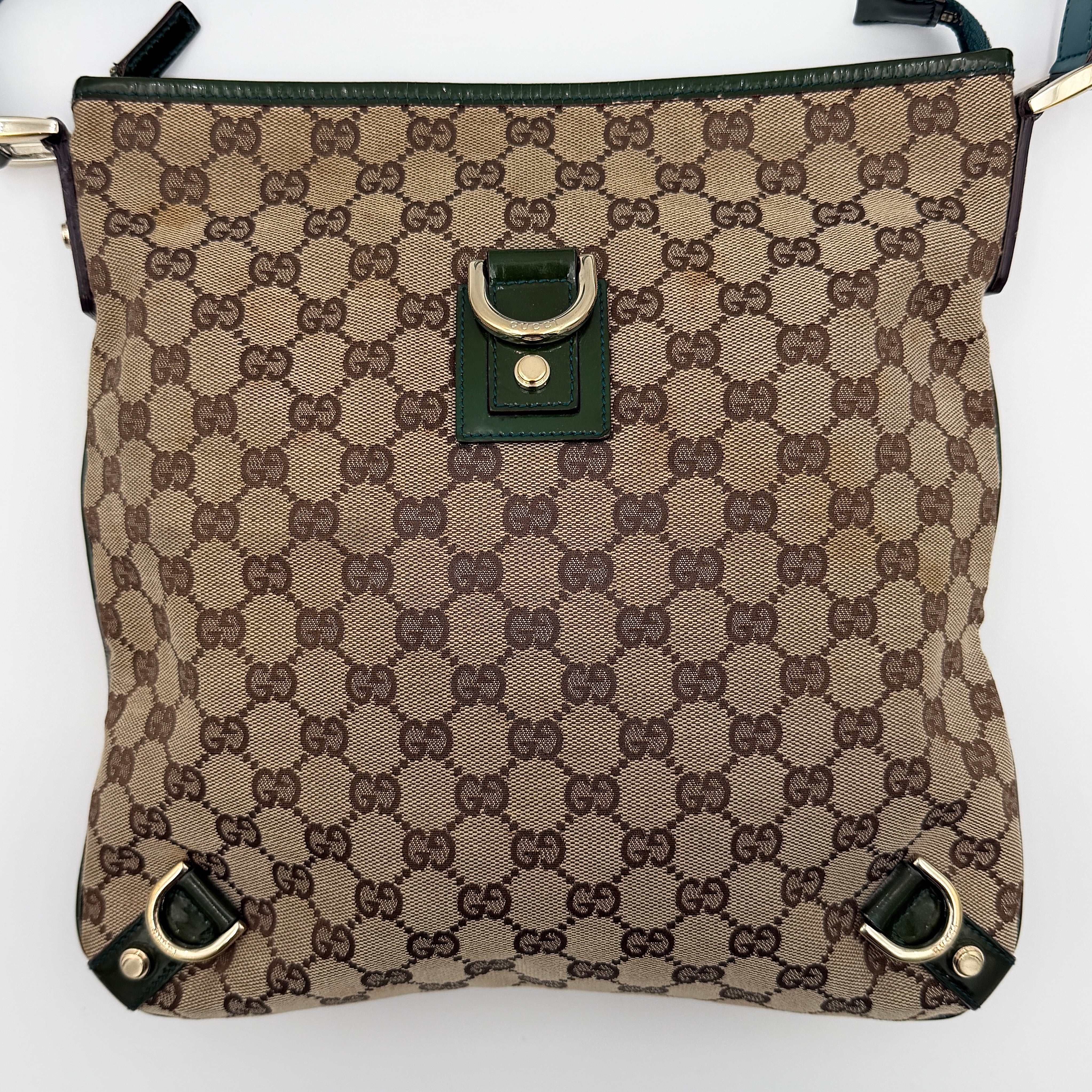 Gucci GG Monogram Abbey D Ring Crossbody Bag in beige canvas with green leather trim and gold-tone hardware, featuring an adjustable green strap.