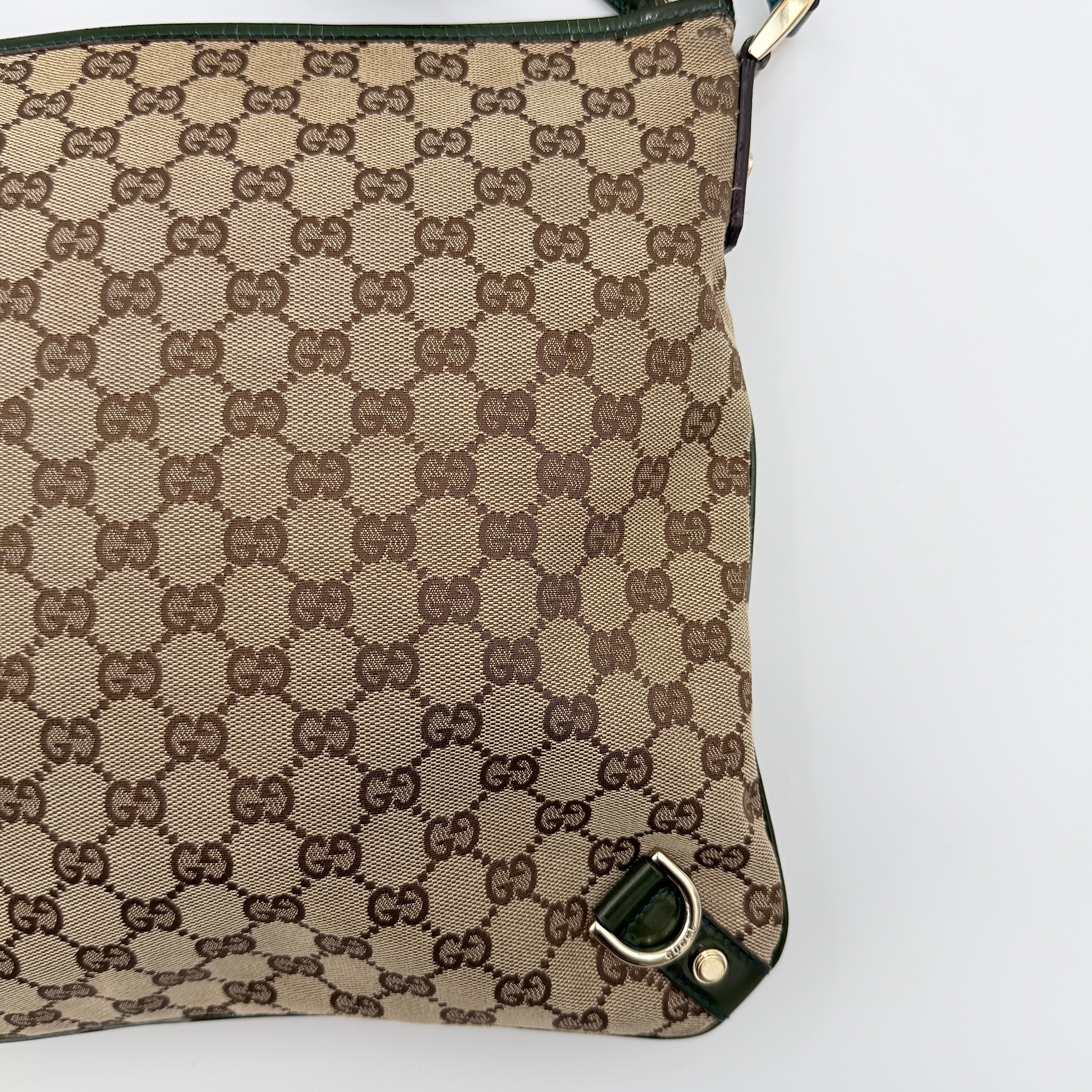 Gucci GG Monogram Abbey D Ring Crossbody Bag in beige canvas with green leather trim and gold-tone hardware, featuring an adjustable green strap.