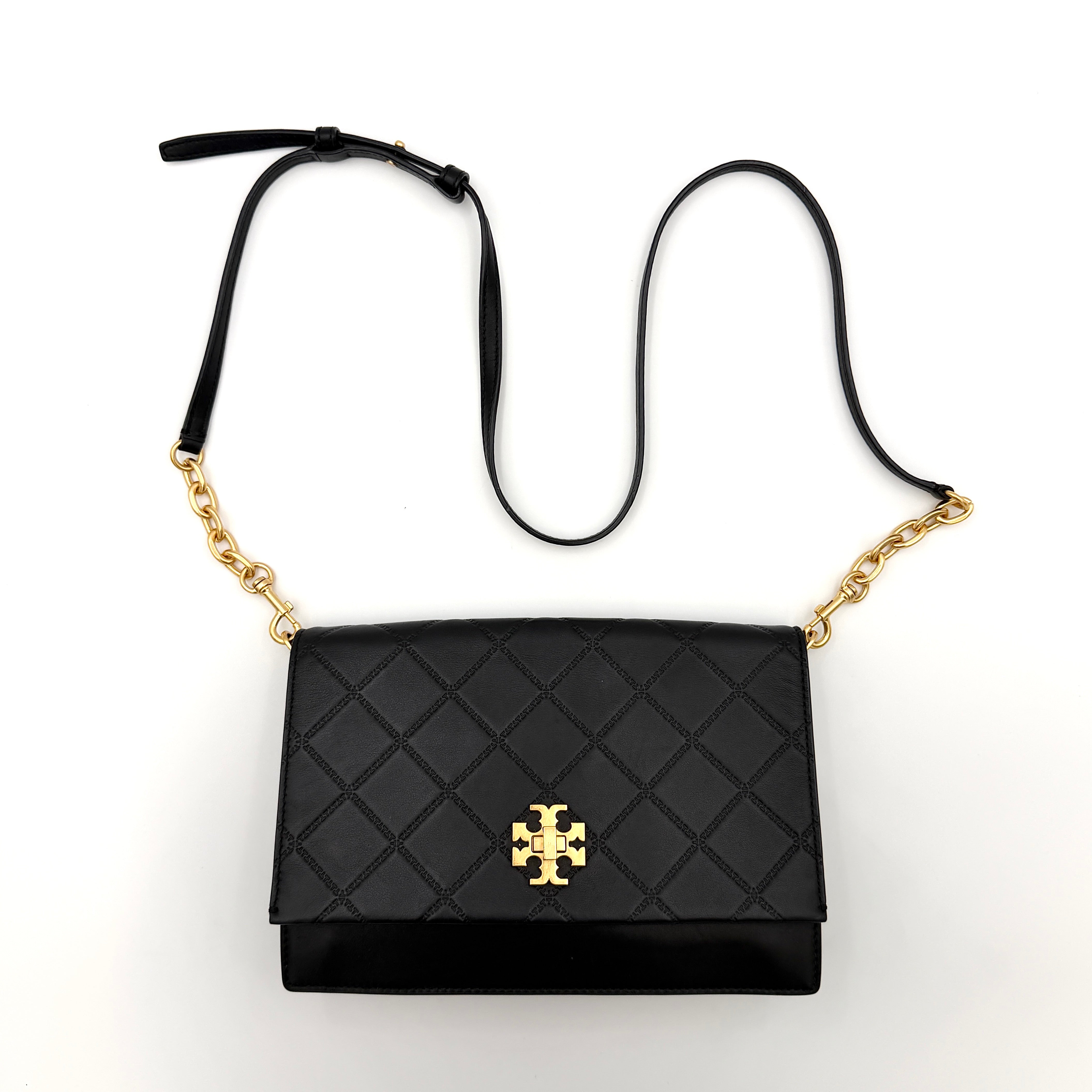 Tory Burch Georgia crossbody in black quilted leather with gold hardware, styled with adjustable chain and leather strap.