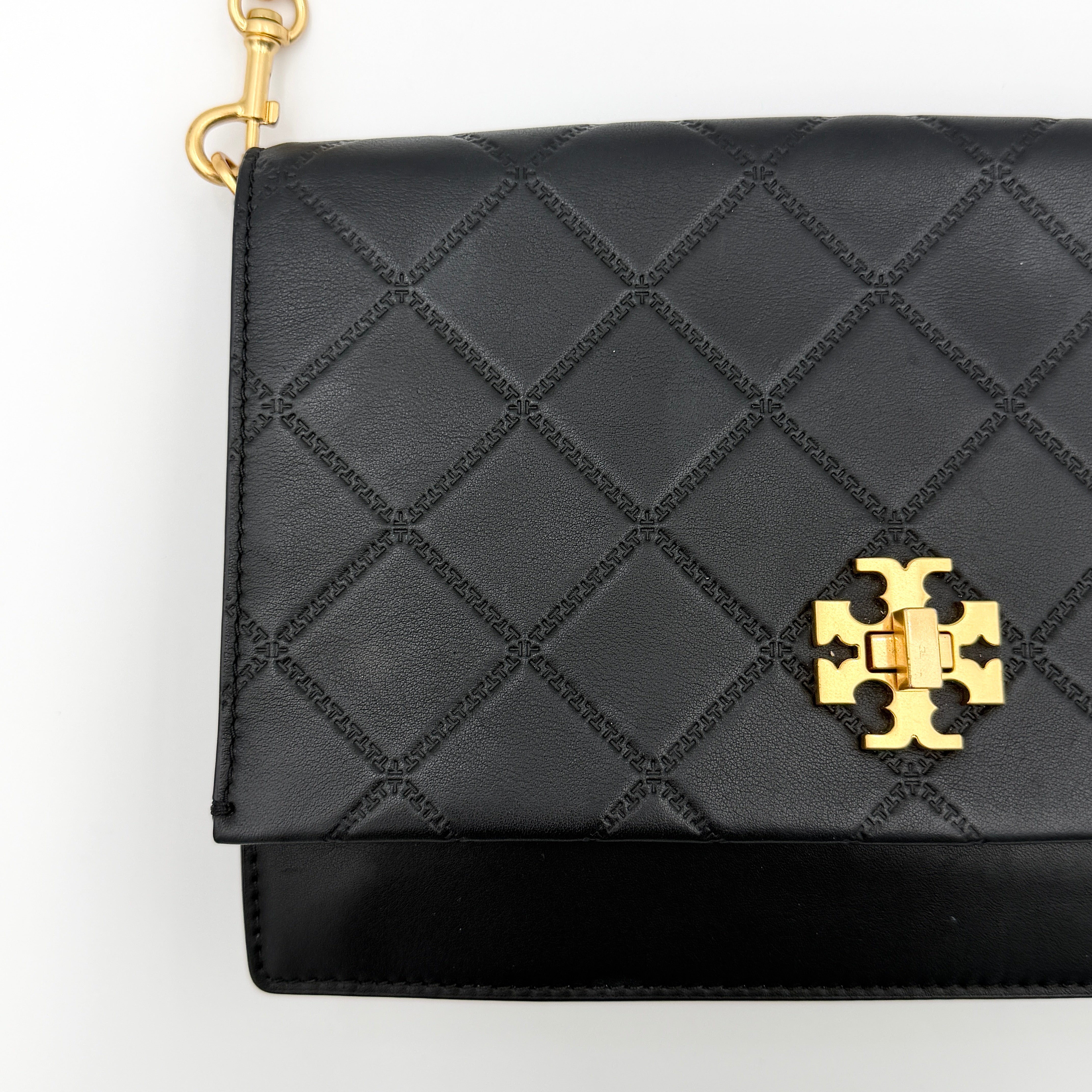 Tory Burch Georgia crossbody in black quilted leather with gold hardware, styled with adjustable chain and leather strap.