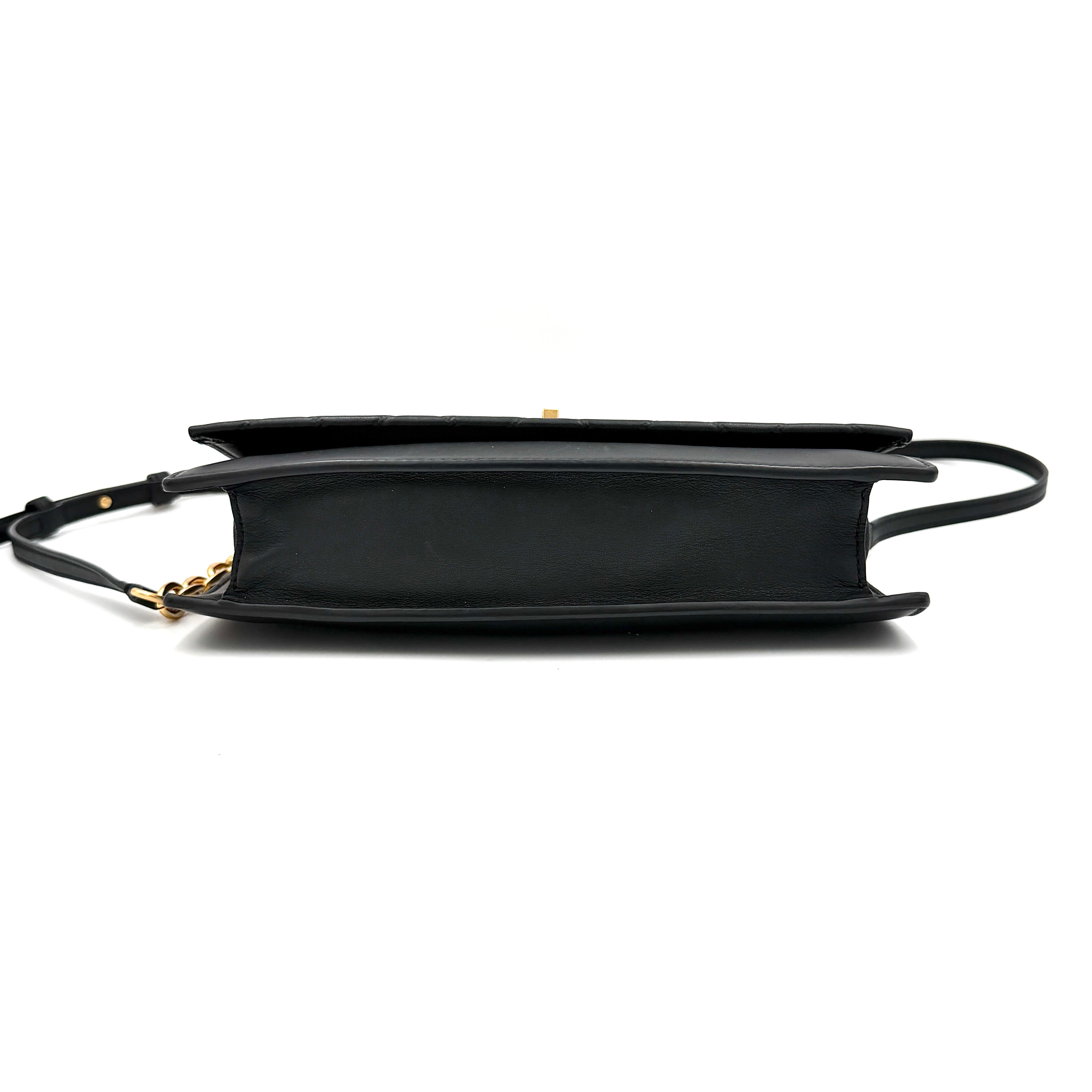 Tory Burch Georgia crossbody in black quilted leather with gold hardware, styled with adjustable chain and leather strap.
