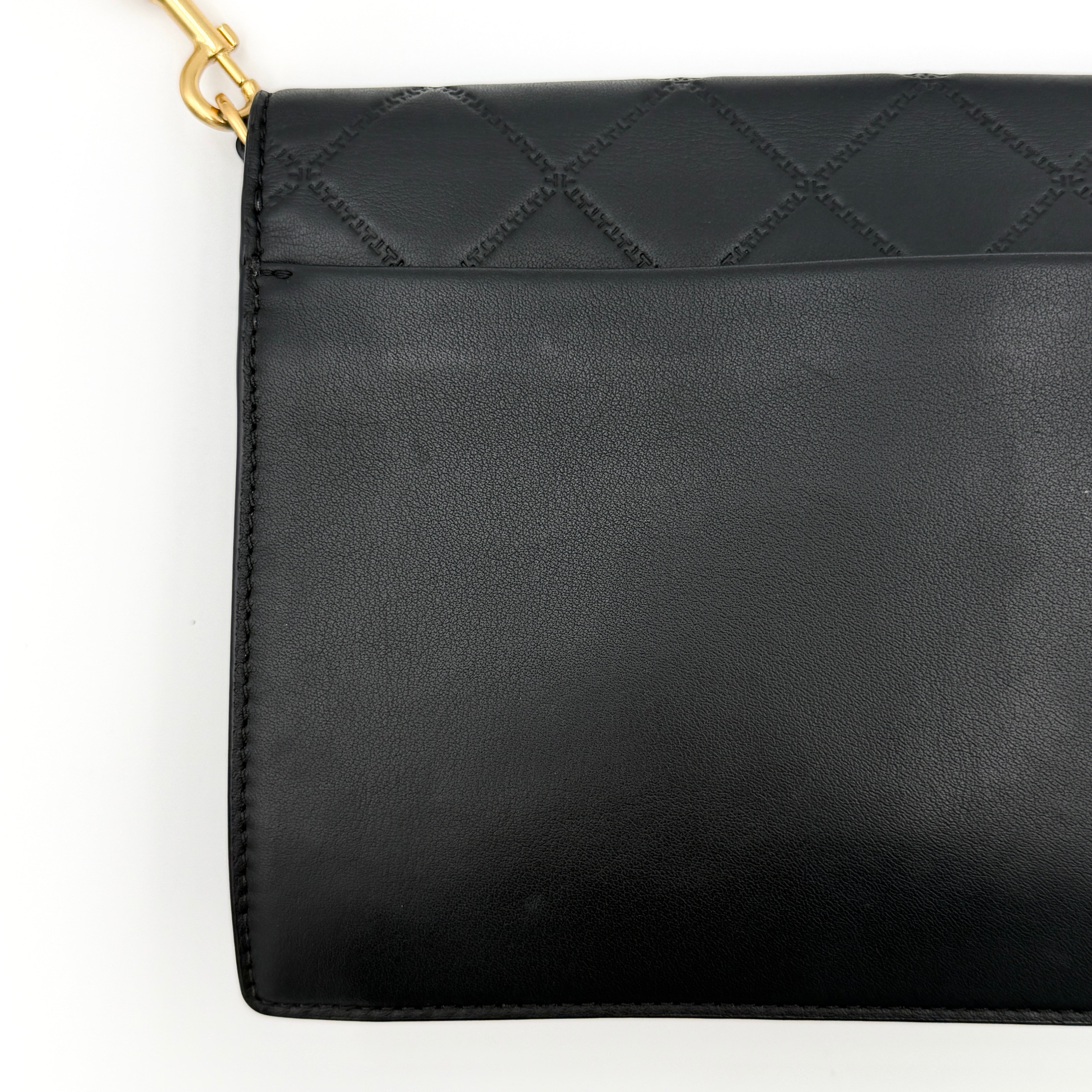 Tory Burch Georgia crossbody in black quilted leather with gold hardware, styled with adjustable chain and leather strap.