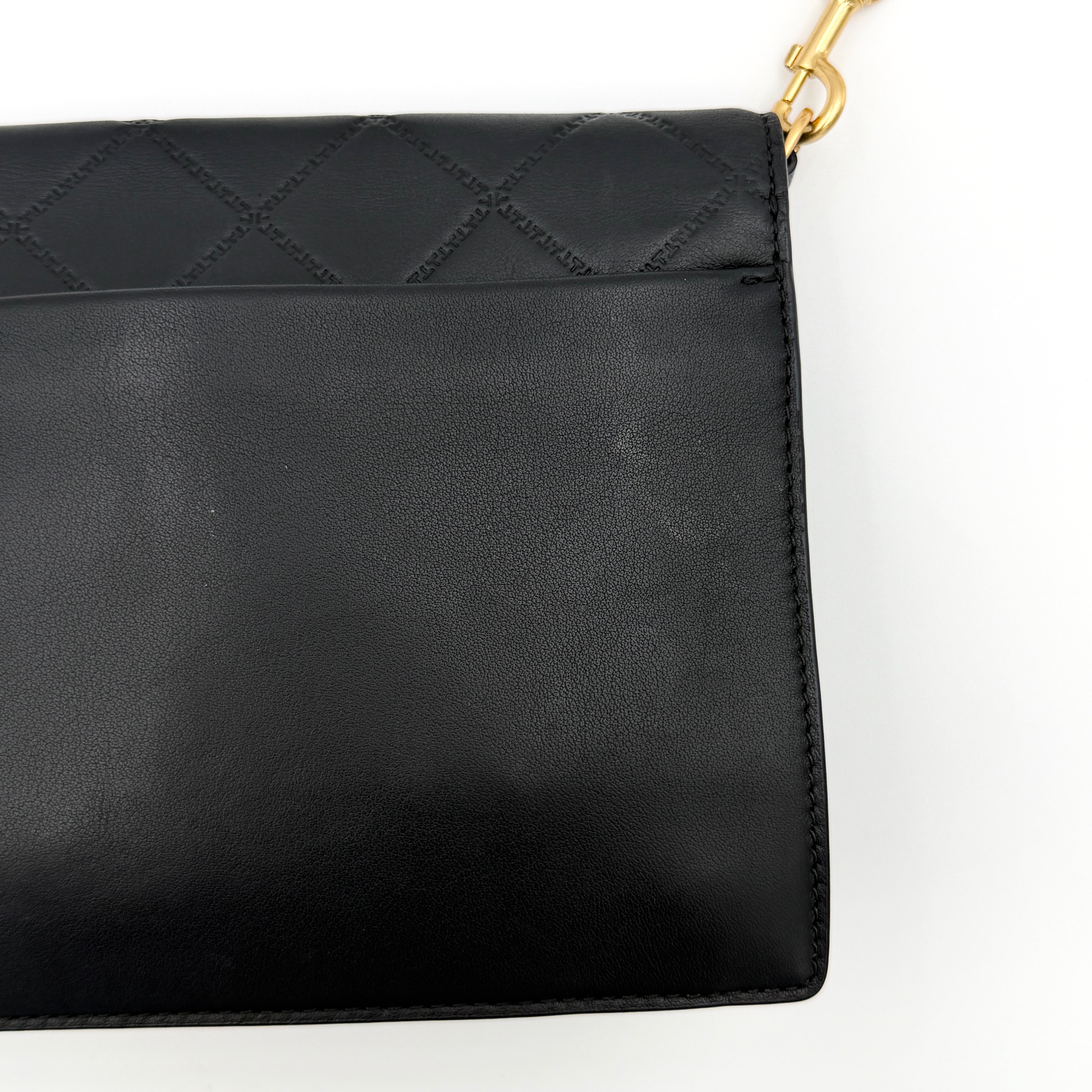 Tory Burch Georgia crossbody in black quilted leather with gold hardware, styled with adjustable chain and leather strap.