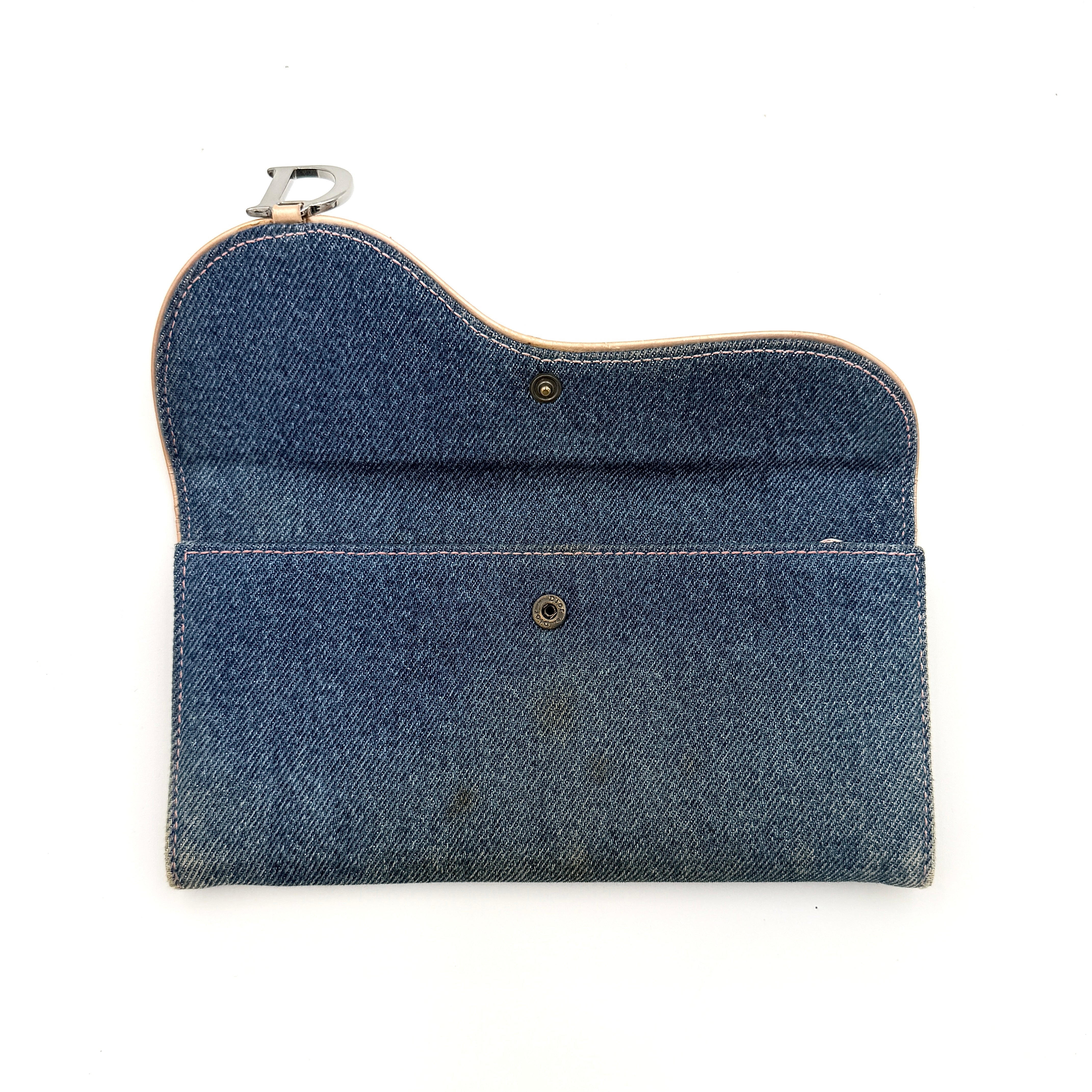 Dior Saddle Denim Wallet in blue denim with signature curved silhouette and silver-tone 'D' charm on the front flap.