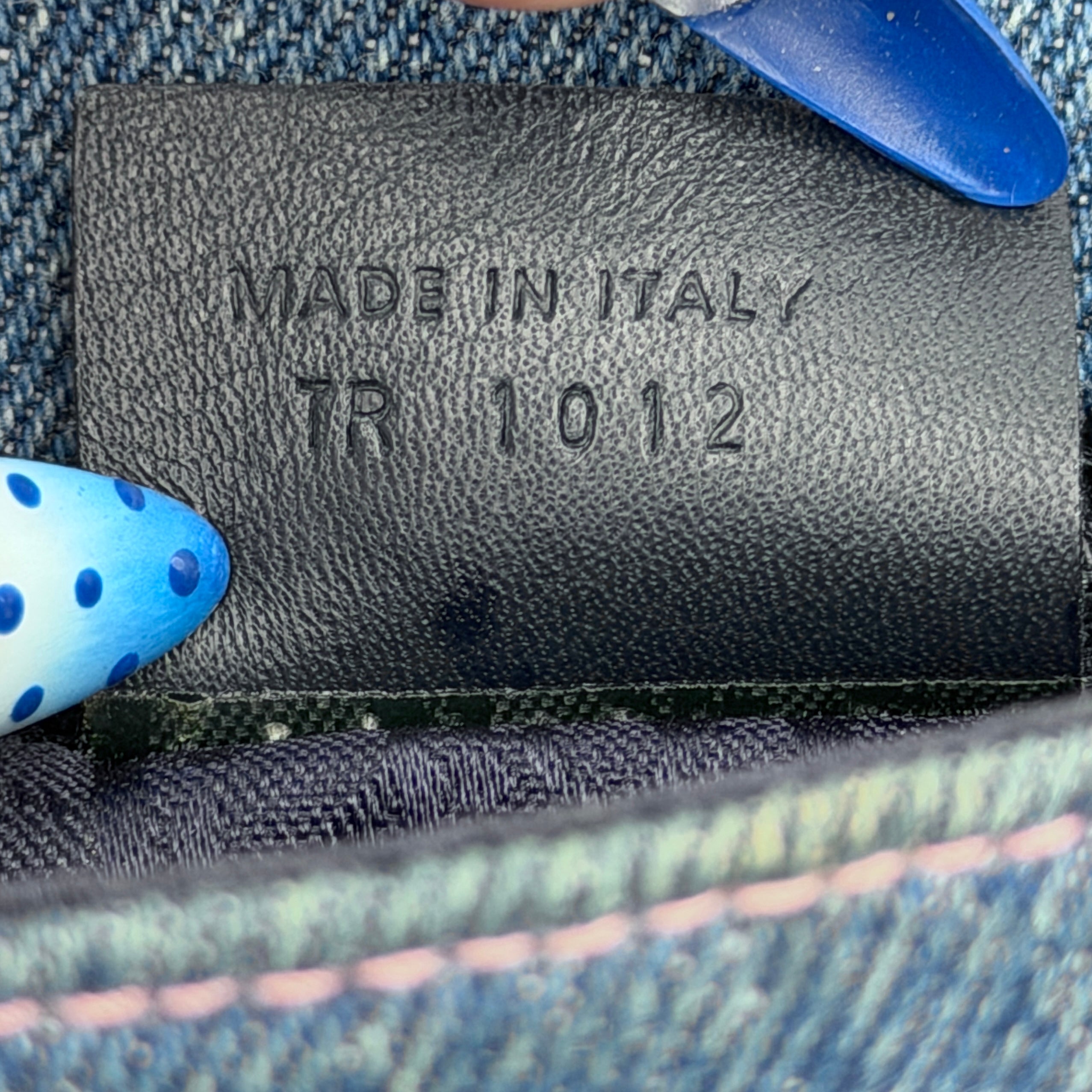 Dior Saddle Denim Wallet in blue denim with signature curved silhouette and silver-tone 'D' charm on the front flap.