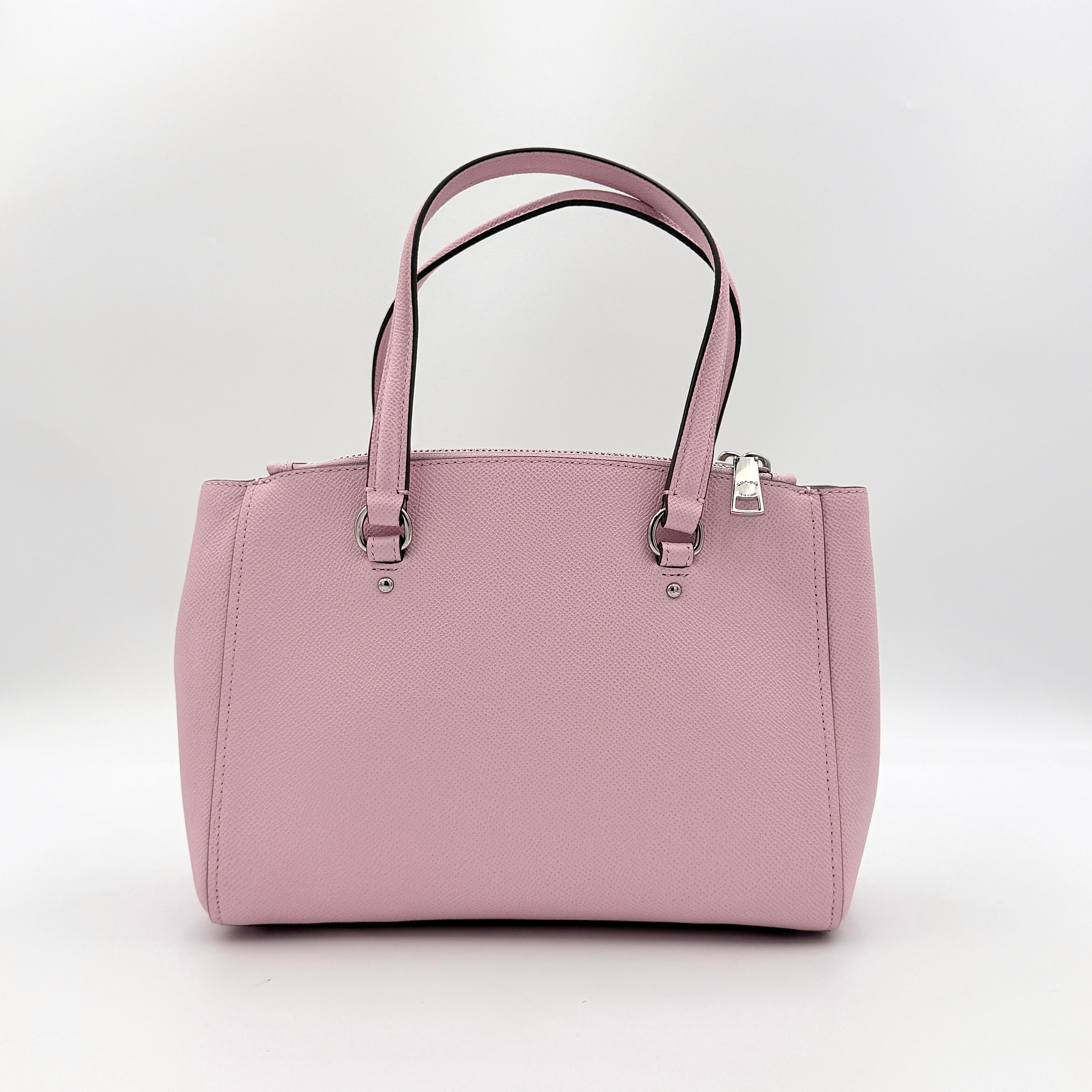 Coach Stanton 26 Carryall in blush pink grained leather with dual handles, silver hardware, and detachable strap.