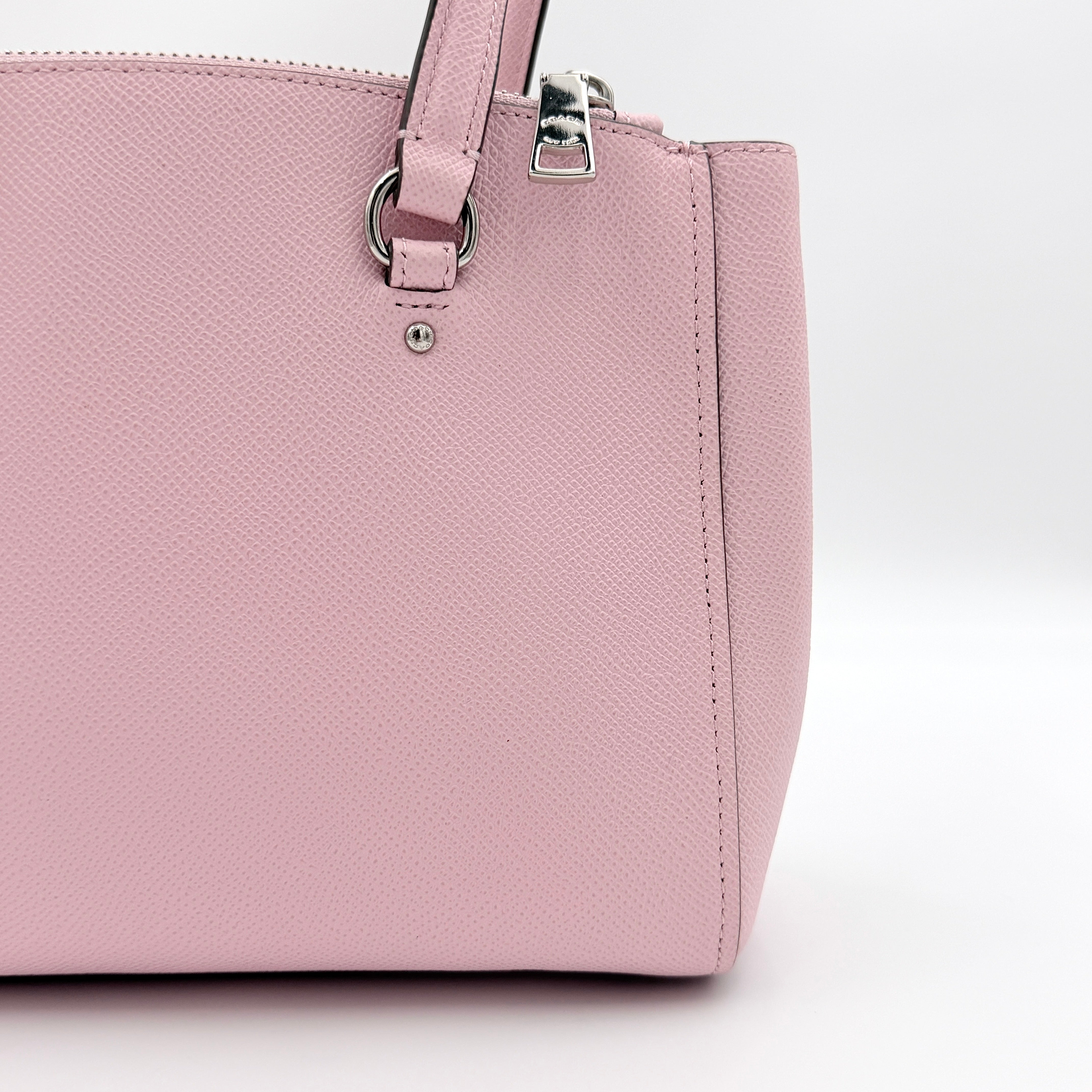 Coach Stanton 26 Carryall in blush pink grained leather with dual handles, silver hardware, and detachable strap.