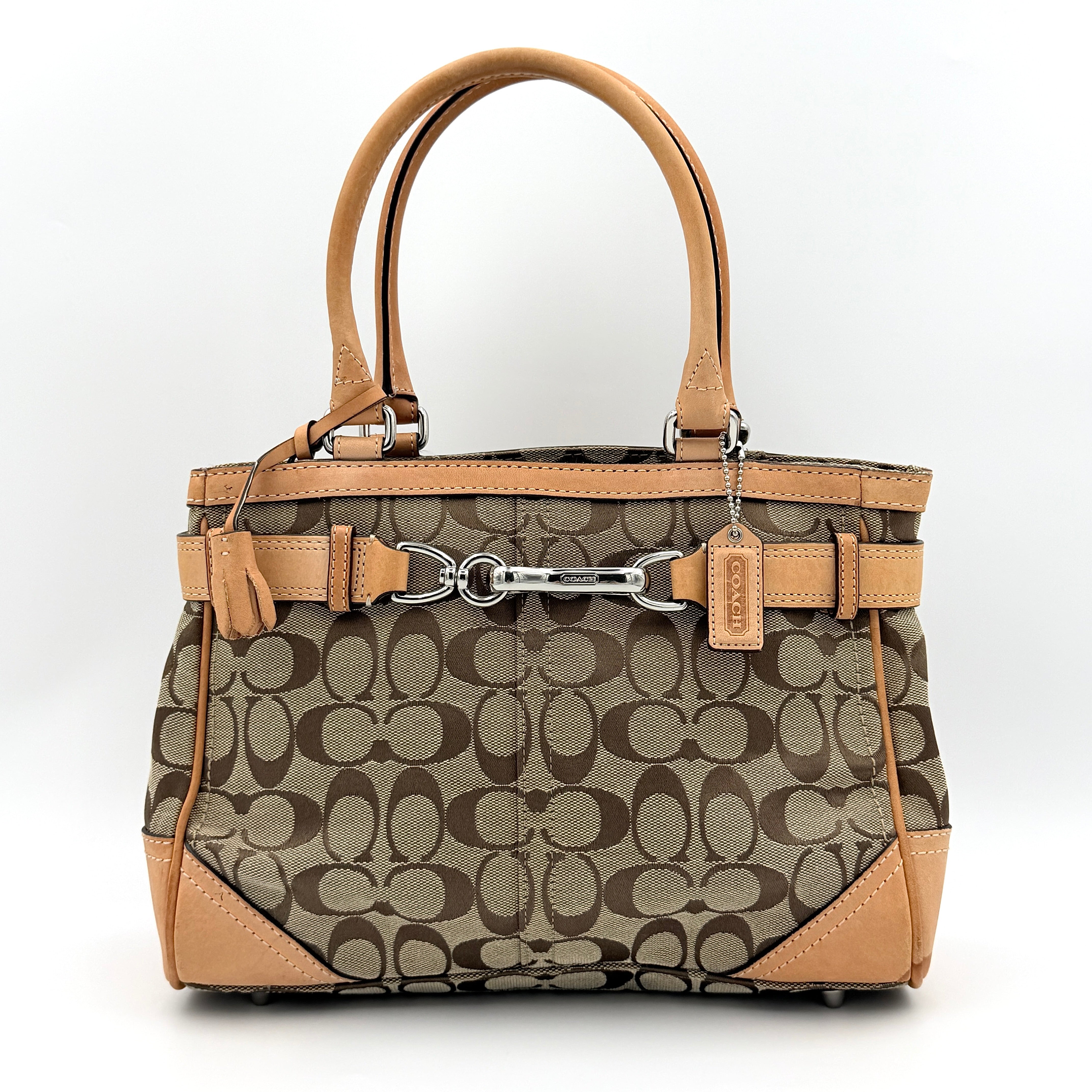 Coach Signature Hampton Clip Shoulder Bag in beige and brown jacquard canvas with leather trim and silver-tone hardware, displayed upright with twin handles.