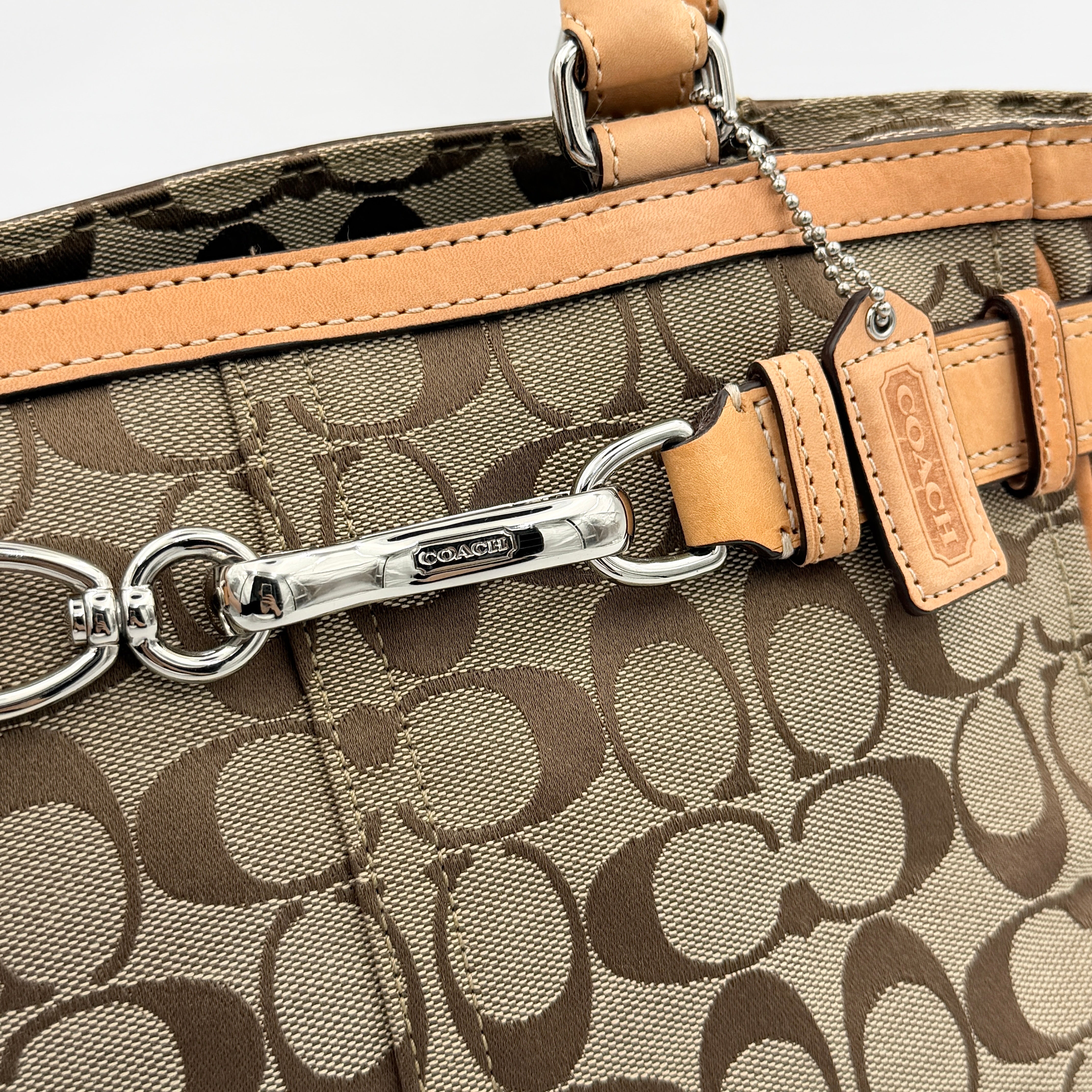 Coach Signature Hampton Clip Shoulder Bag in beige and brown jacquard canvas with leather trim and silver-tone hardware, displayed upright with twin handles.