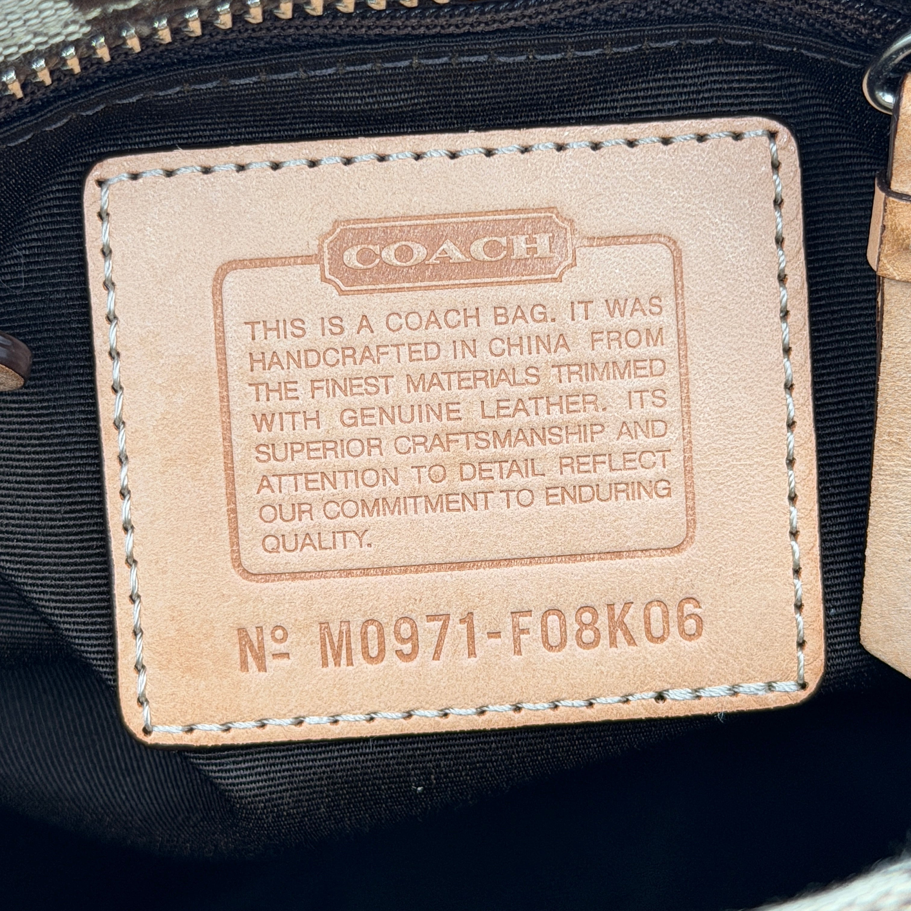 Coach Signature Hampton Clip Shoulder Bag in beige and brown jacquard canvas with leather trim and silver-tone hardware, displayed upright with twin handles.